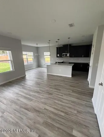 a kitchen with stainless steel appliances kitchen island sink refrigerator and cabinets