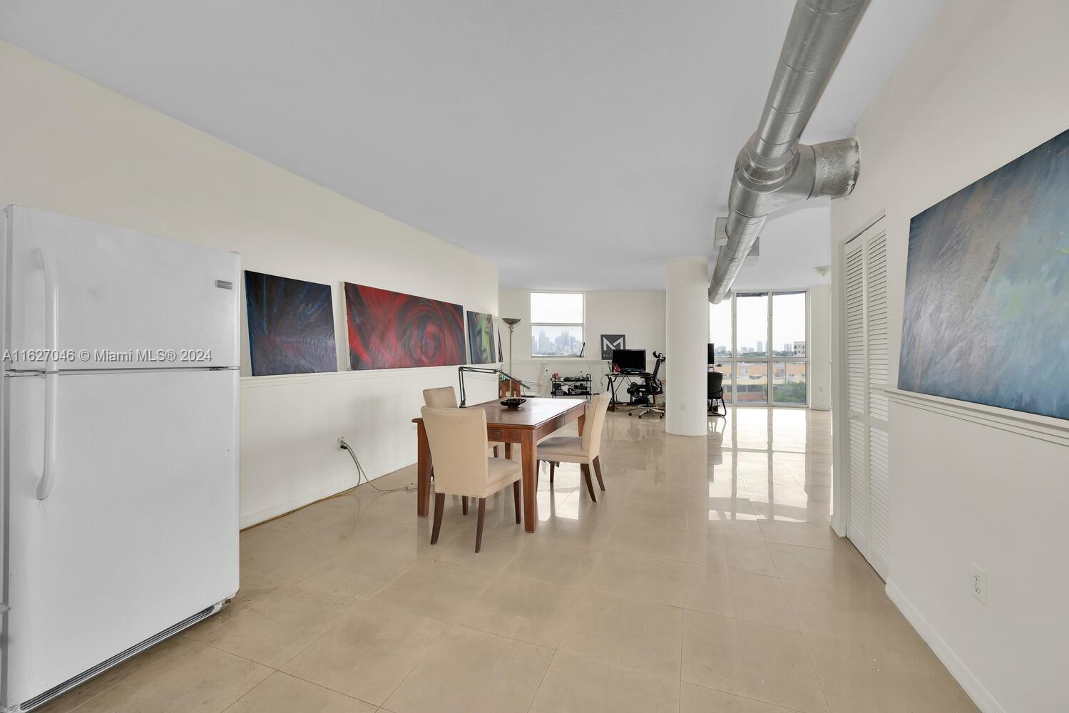 West Flagler Miami, FL 33125 - Photo 15 of 29 a dining room with furniture and a kitchen view