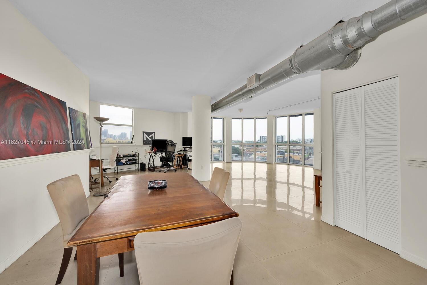 West Flagler Miami, FL 33125 - Photo 16 of 29 a view of a dining room with furniture and a large window