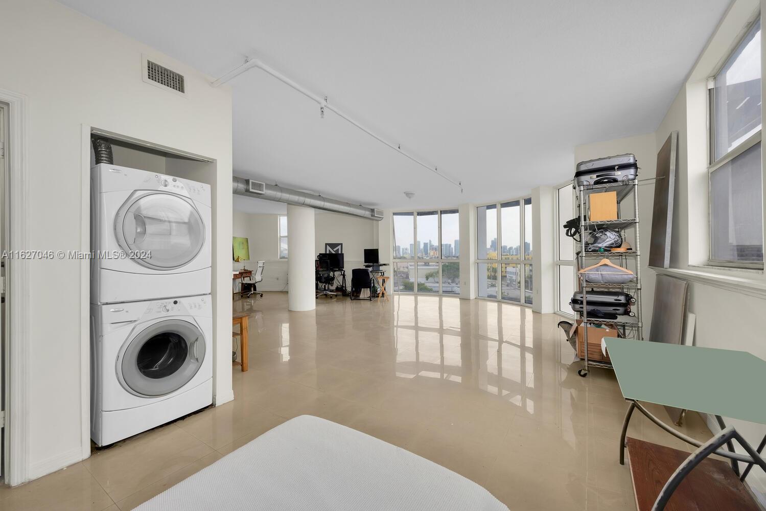 West Flagler Miami, FL 33125 - Photo 21 of 29 a living room with furniture a rug and a floor to ceiling window