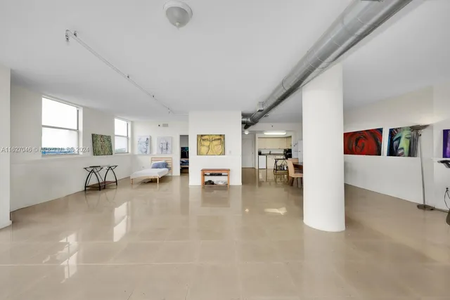 a view of a livingroom with couch and white walls