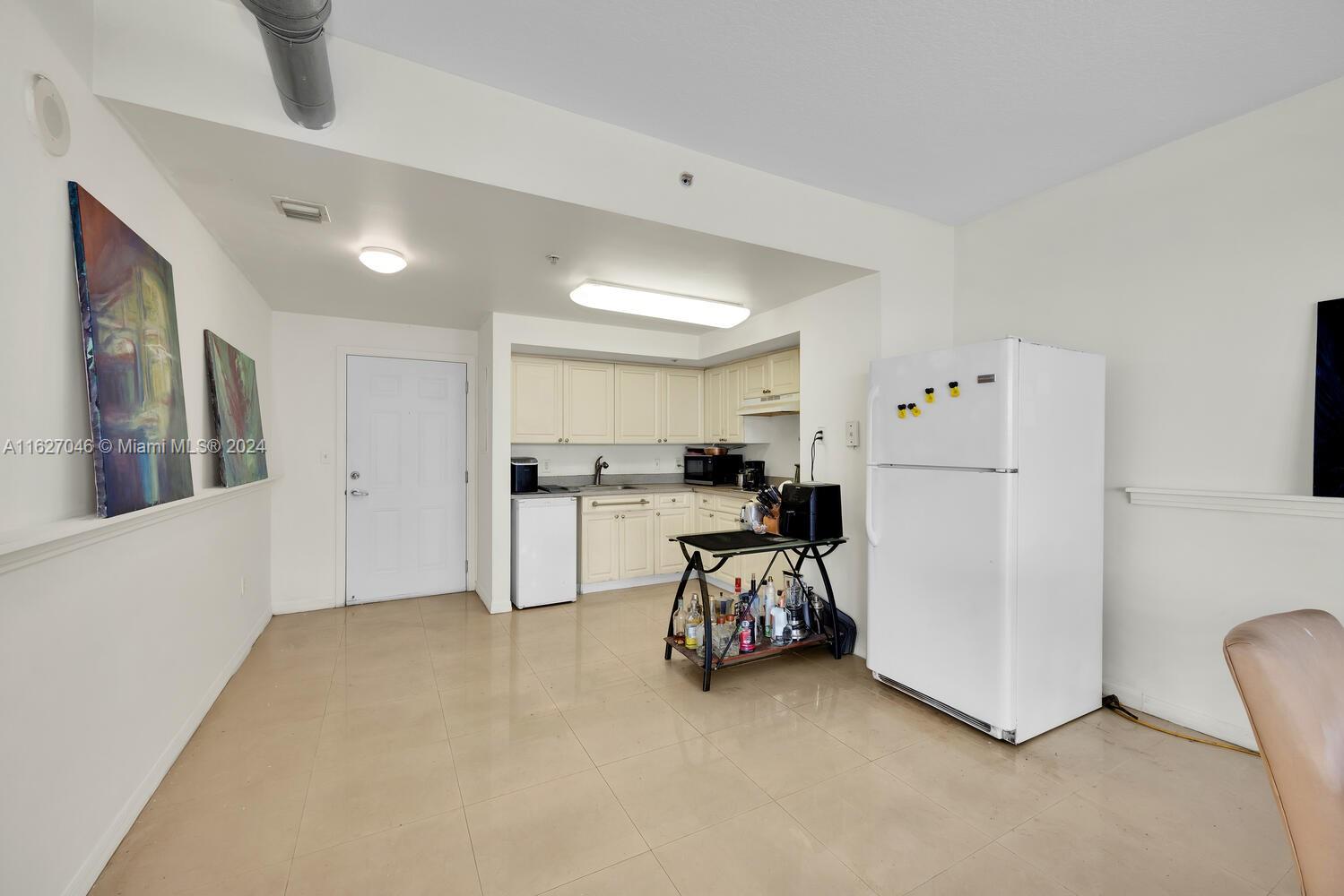 West Flagler Miami, FL 33125 - Photo 10 of 29 a view of a kitchen with furniture and a refrigerator