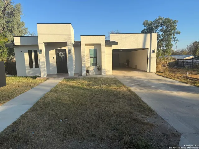 a view of a house with a yard and garage