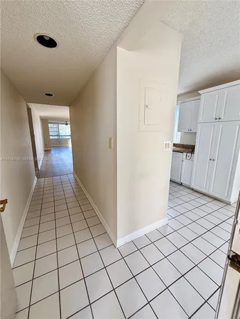 a kitchen with granite countertop a sink stove top oven and cabinets