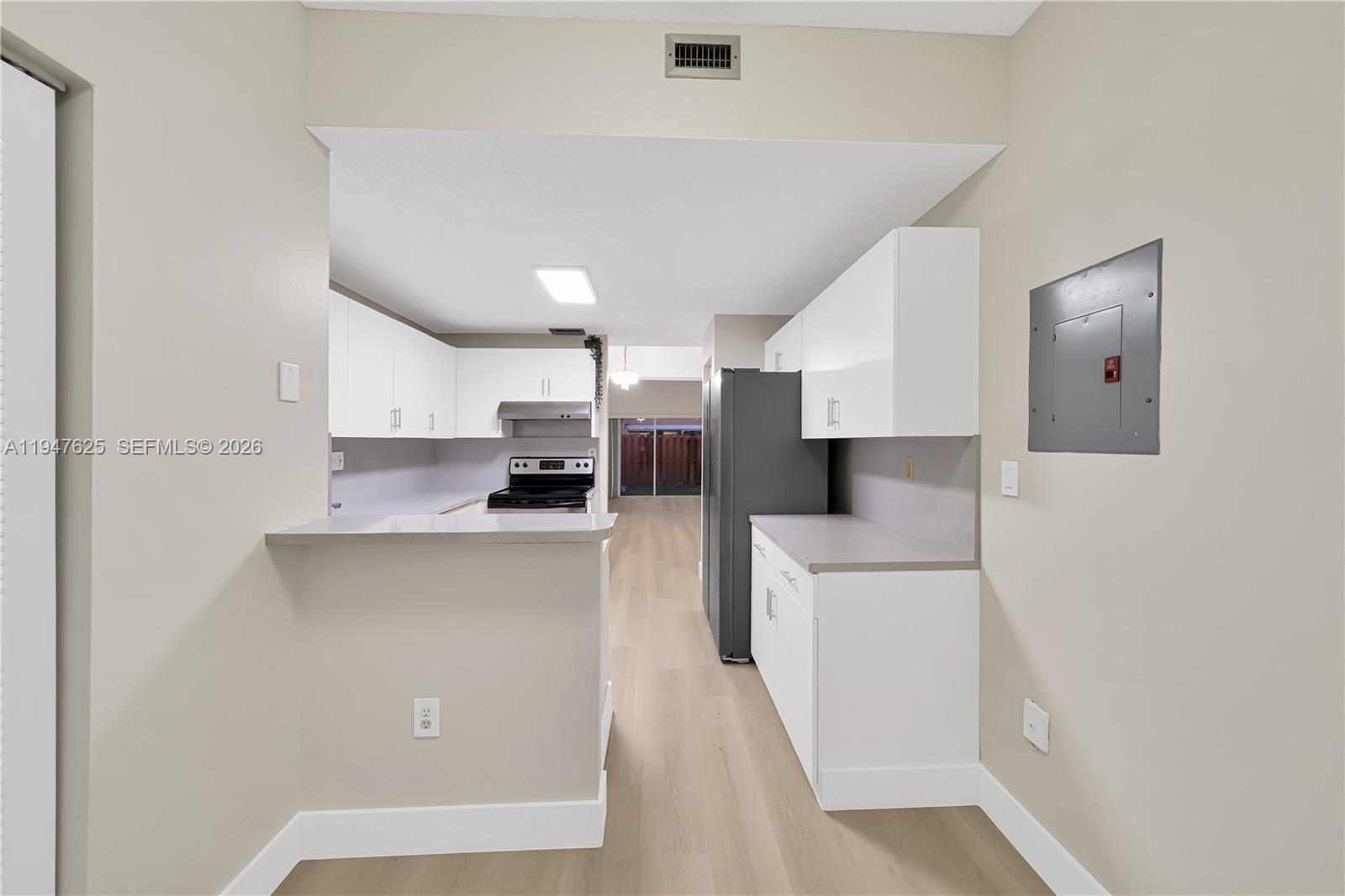 14325 Southwest 57th Lane, Unit 66 Miami, FL 33183 - Photo 11 of 22 a kitchen with stainless steel appliances a refrigerator and a stove top oven