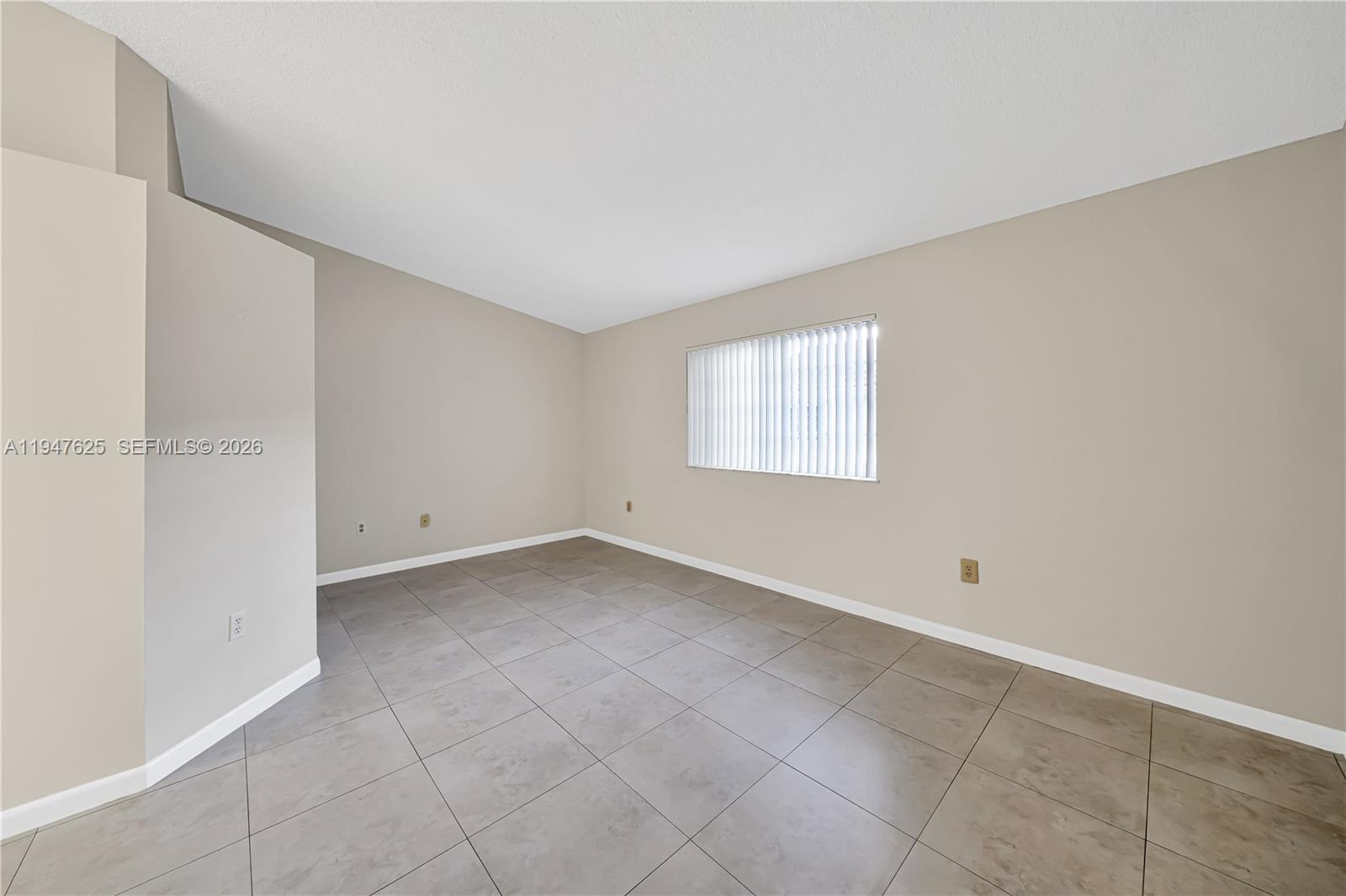 14325 Southwest 57th Lane, Unit 66 Miami, FL 33183 - Photo 13 of 22 a view of an empty room with a window
