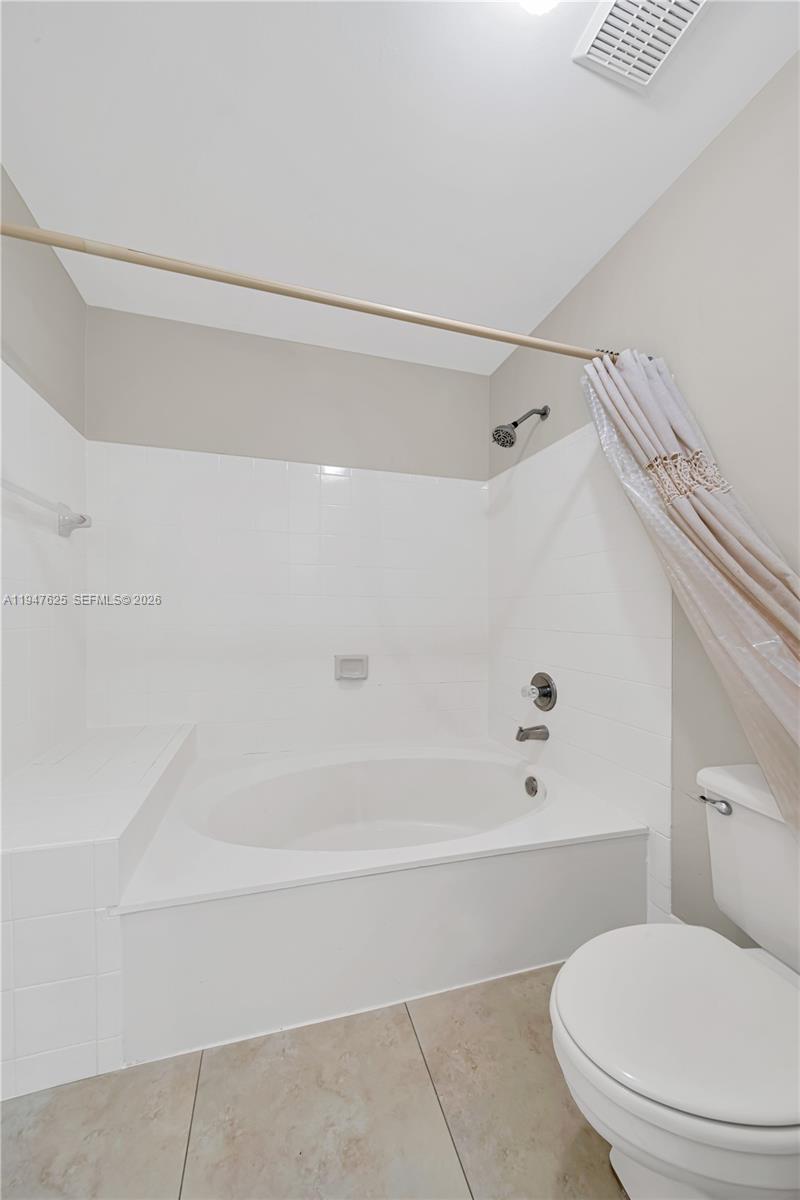 14325 Southwest 57th Lane, Unit 66 Miami, FL 33183 - Photo 15 of 22 a bathroom with a toilet and a bathtub