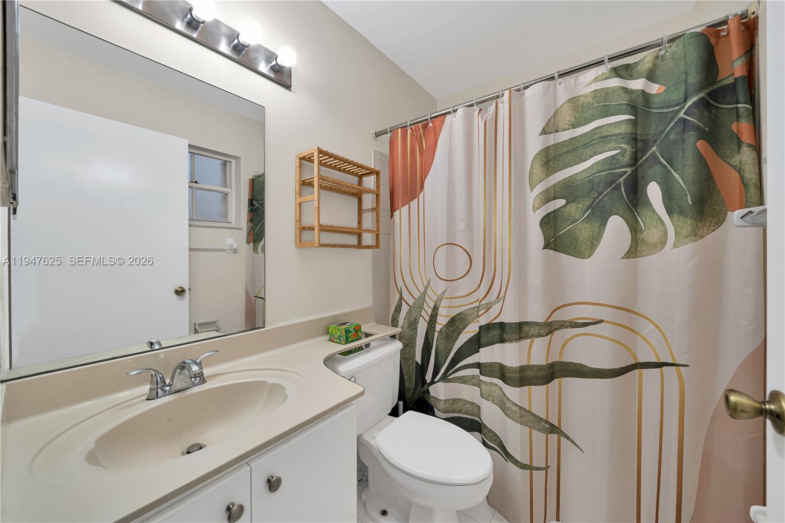 14325 Southwest 57th Lane, Unit 66 Miami, FL 33183 - Photo 17 of 22 a bathroom with a sink a mirror a toilet and a mirror