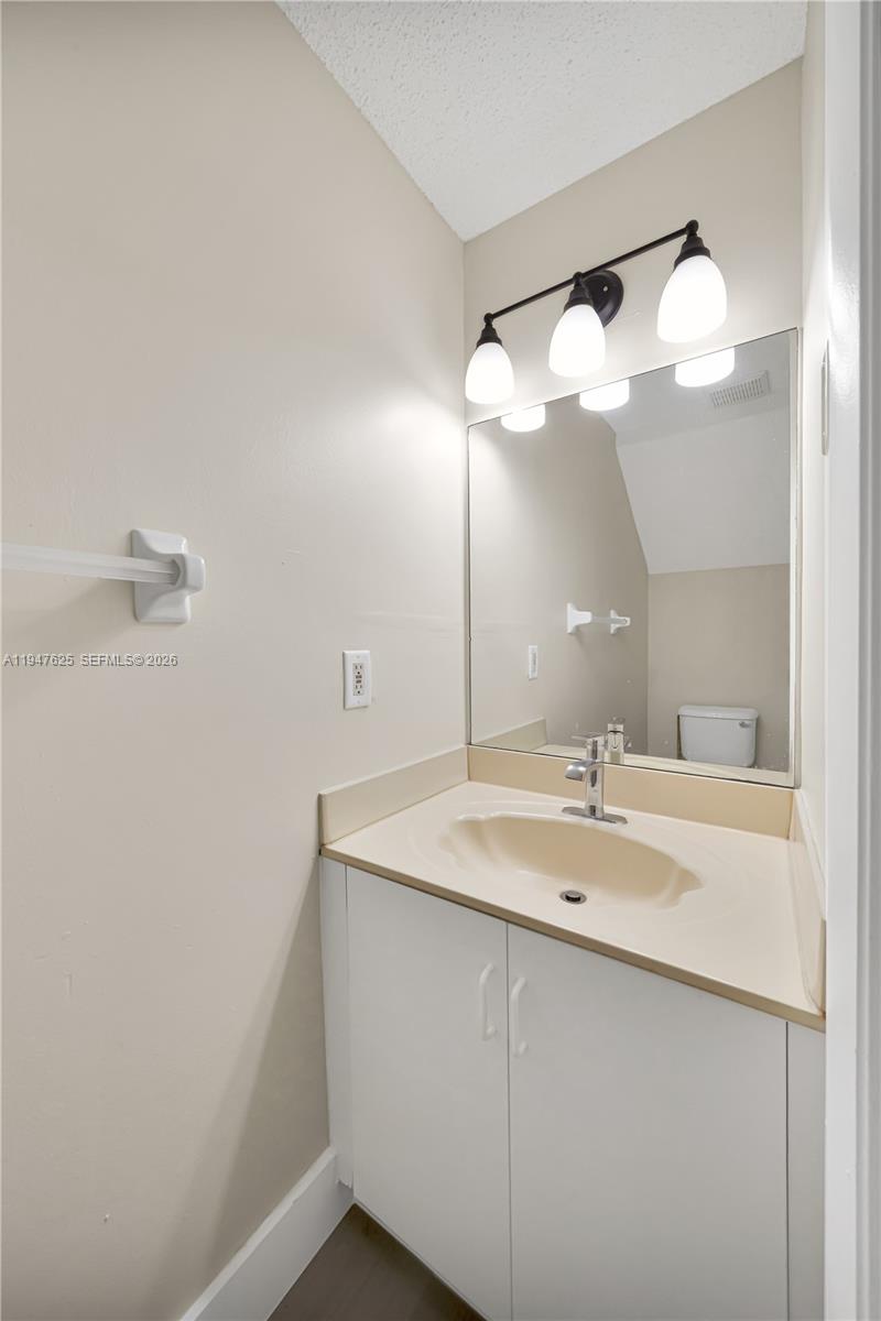 14325 Southwest 57th Lane, Unit 66 Miami, FL 33183 - Photo 21 of 22 a bathroom with a sink and mirror
