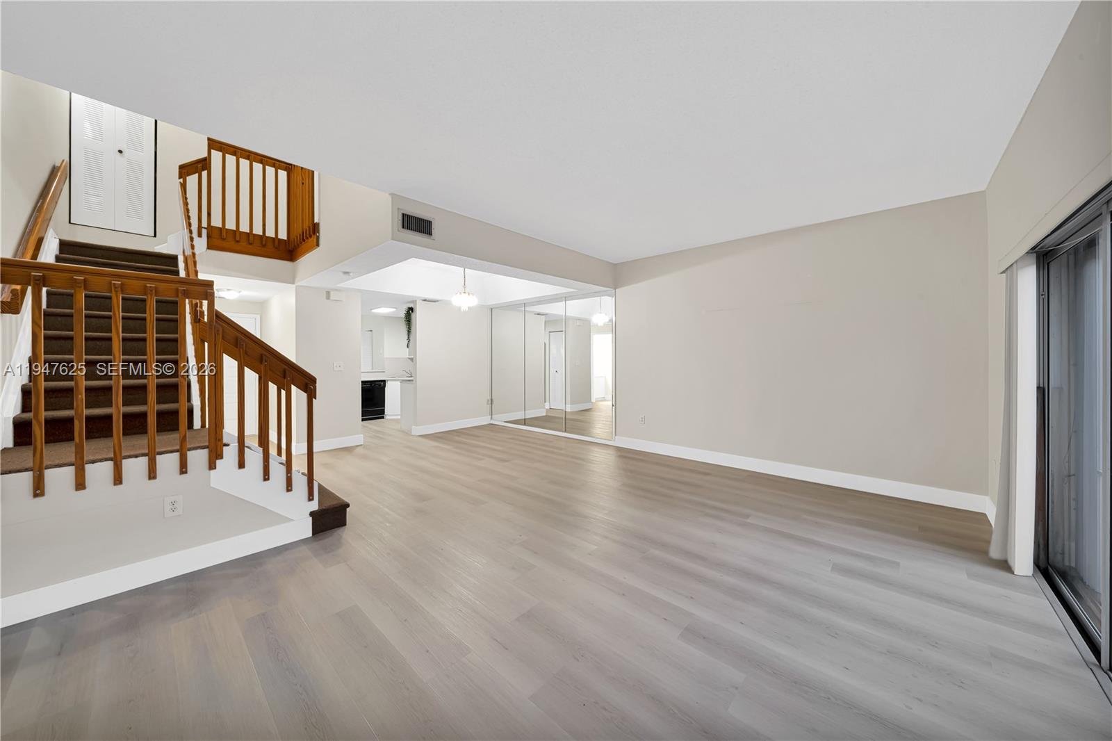 14325 Southwest 57th Lane, Unit 66 Miami, FL 33183 - Photo 6 of 22 an empty room with wooden floor and windows