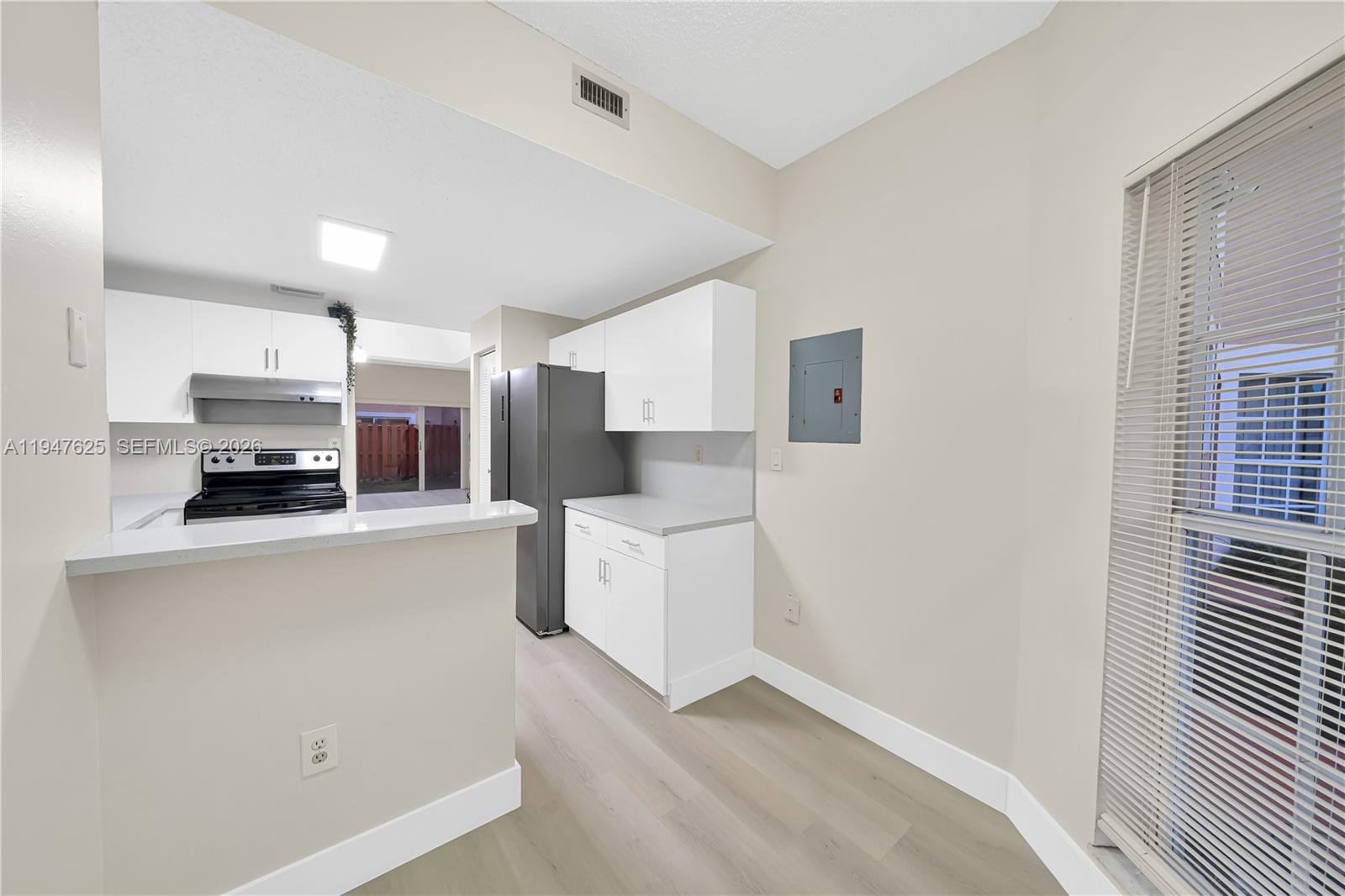 14325 Southwest 57th Lane, Unit 66 Miami, FL 33183 - Photo 10 of 22 a kitchen with stainless steel appliances a refrigerator and a stove top oven