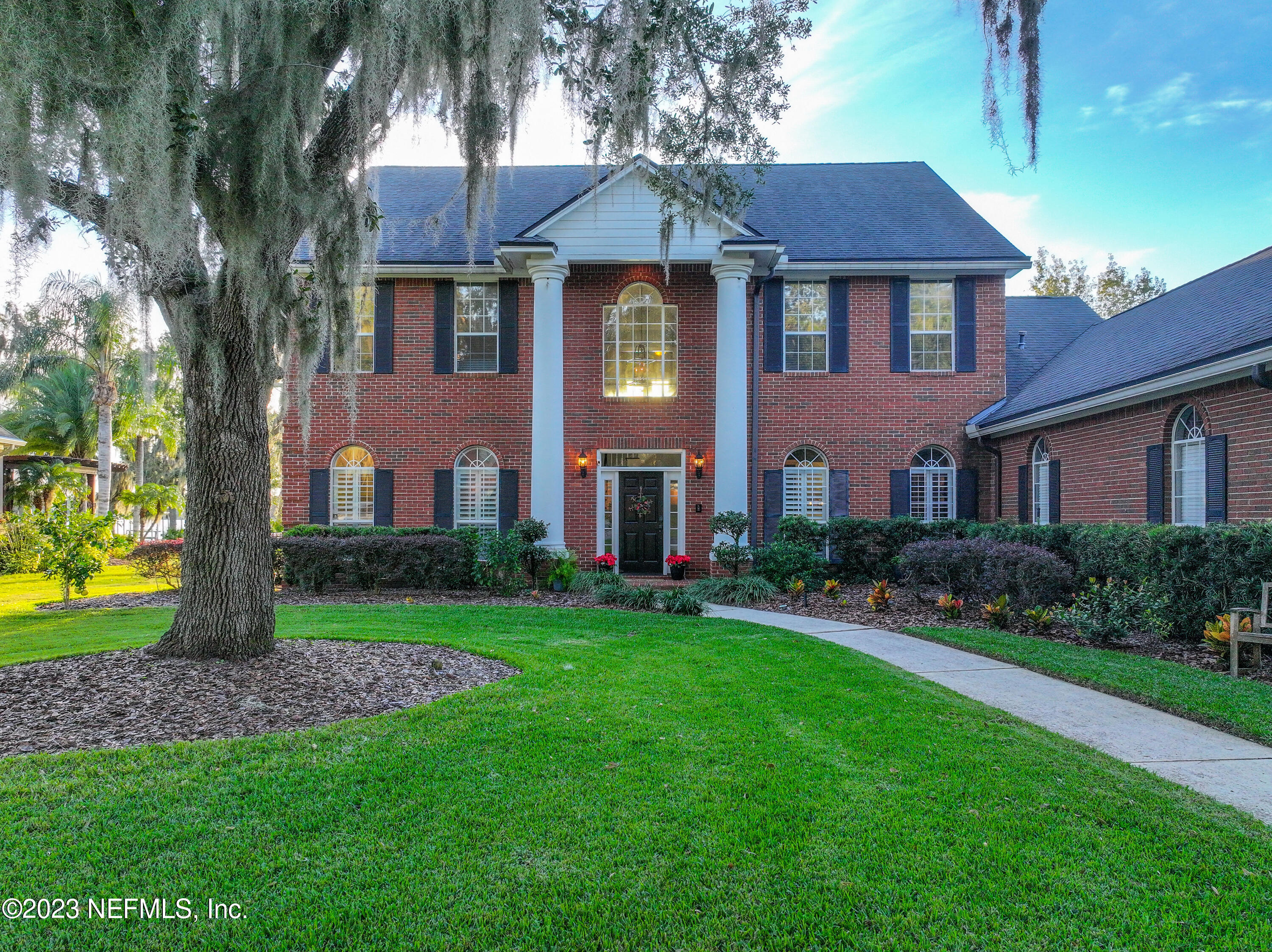 2011 Salt Myrtle Lane Fleming Island, FL 32003 - Photo 115 of 124 a front view of a house with a yard