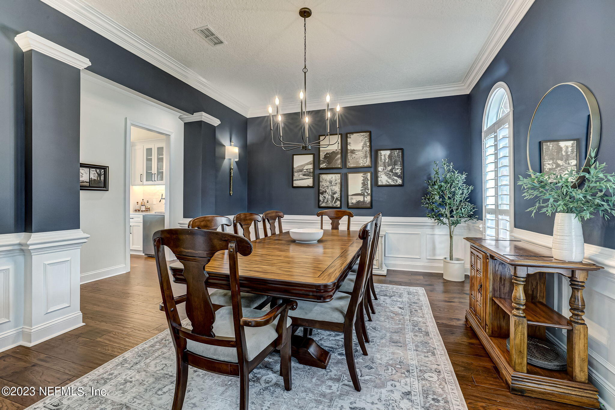 2011 Salt Myrtle Lane Fleming Island, FL 32003 - Photo 14 of 124 a dining room with furniture a chandelier and wooden floor