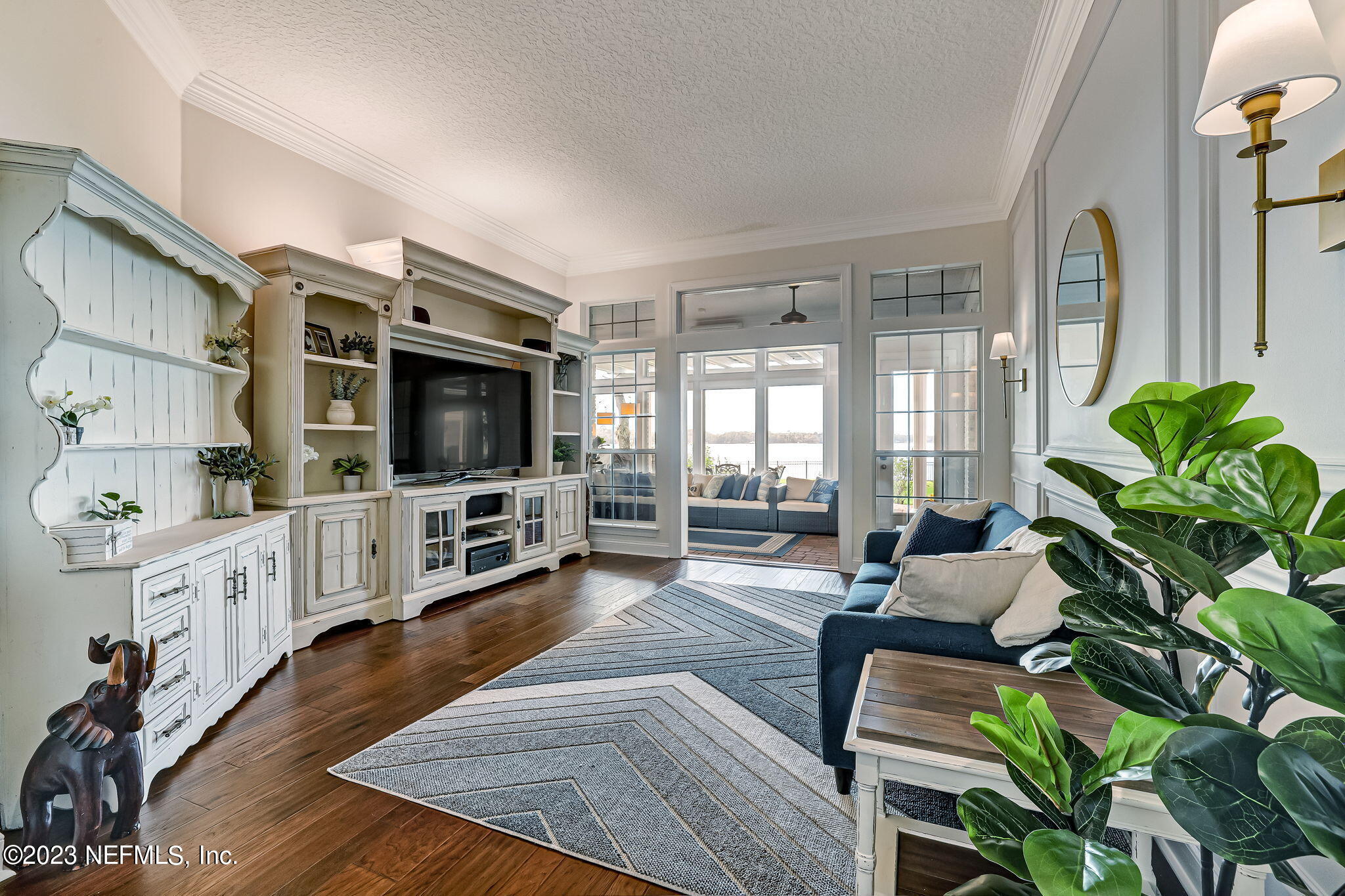 2011 Salt Myrtle Lane Fleming Island, FL 32003 - Photo 16 of 124 a living room with furniture a flat screen tv and a dining table