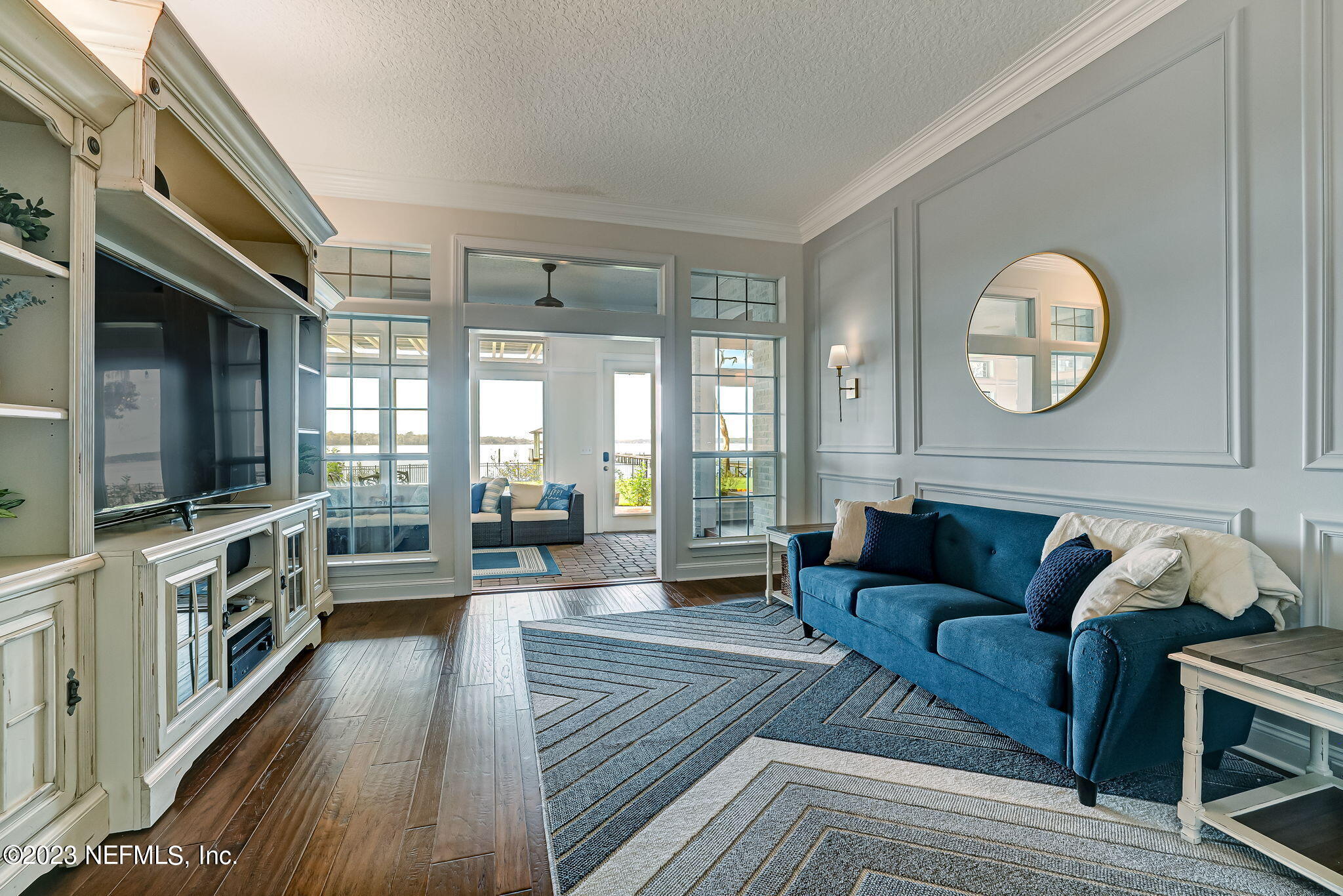 2011 Salt Myrtle Lane Fleming Island, FL 32003 - Photo 17 of 124 a living room with furniture wooden floor and a flat screen tv