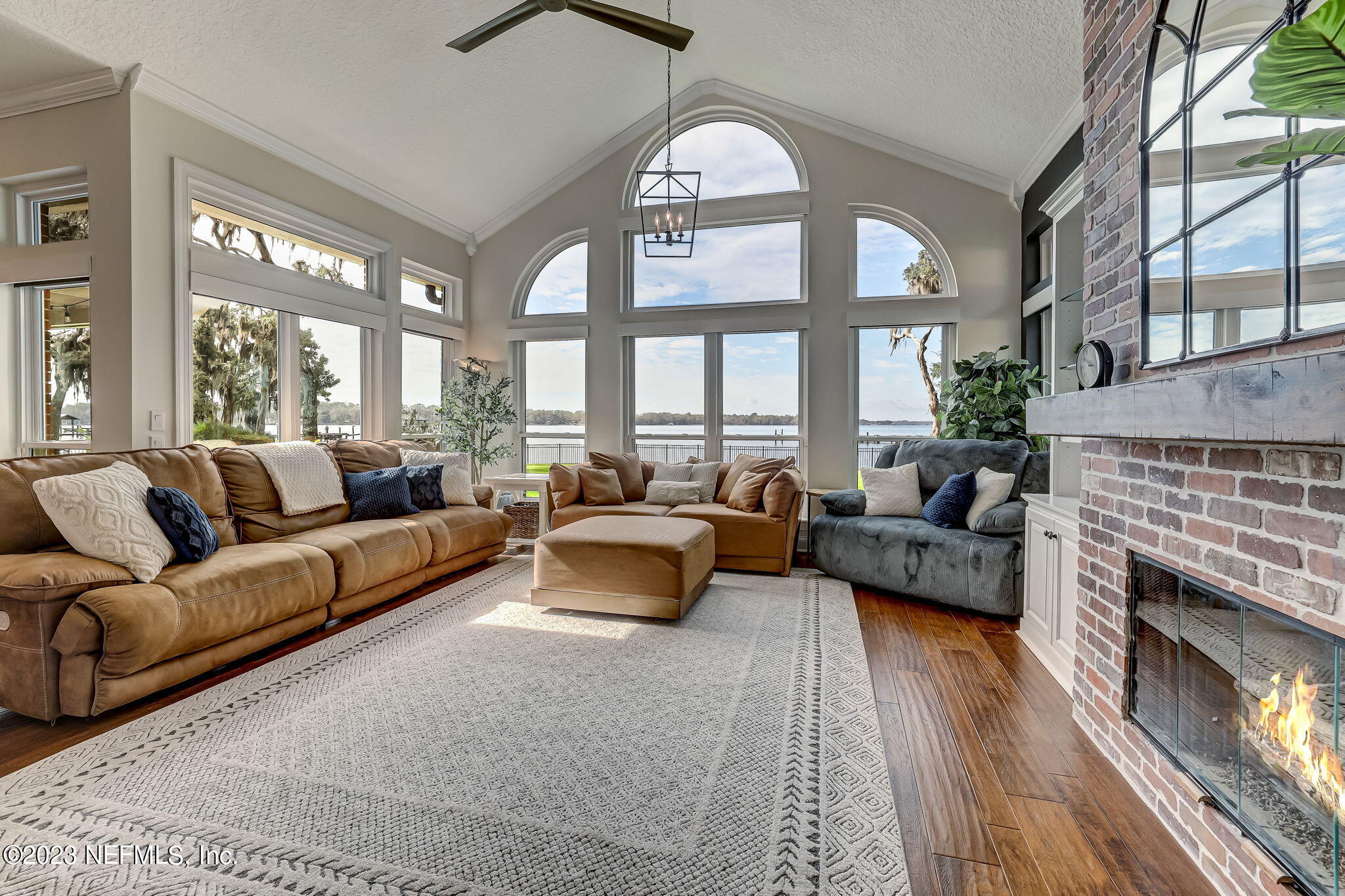 2011 Salt Myrtle Lane Fleming Island, FL 32003 - Photo 20 of 124 a living room with furniture fireplace and a large window
