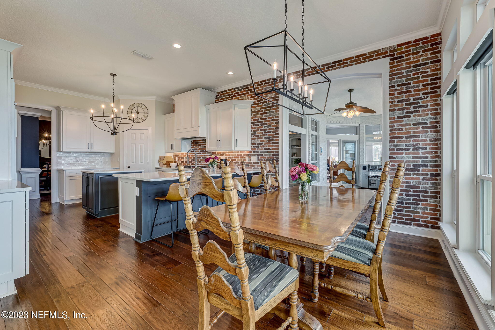 2011 Salt Myrtle Lane Fleming Island, FL 32003 - Photo 33 of 124 a view of a dining room and livingroom with furniture wooden floor a chandelier