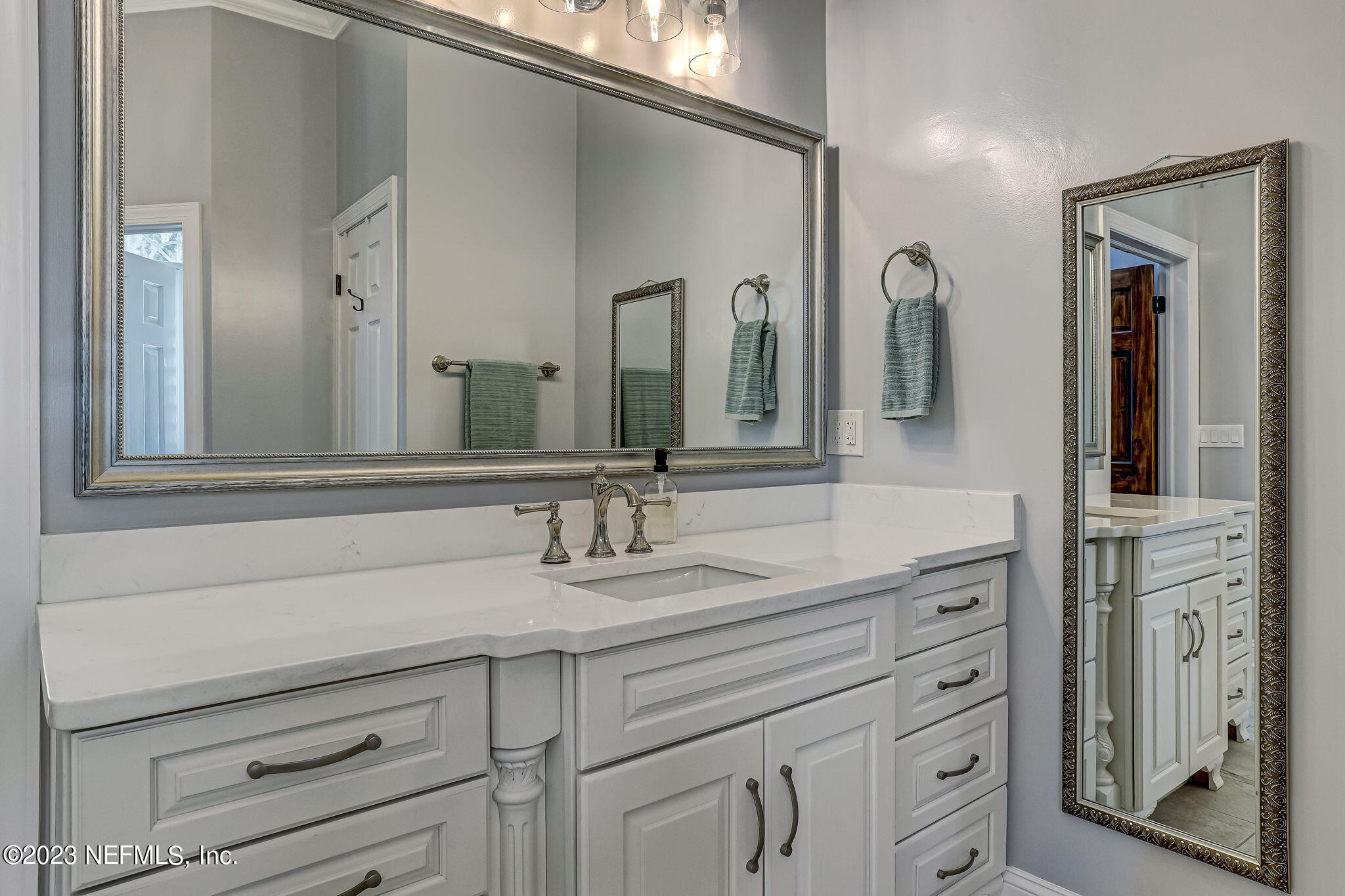 2011 Salt Myrtle Lane Fleming Island, FL 32003 - Photo 41 of 124 a bathroom with a double vanity sink and a mirror