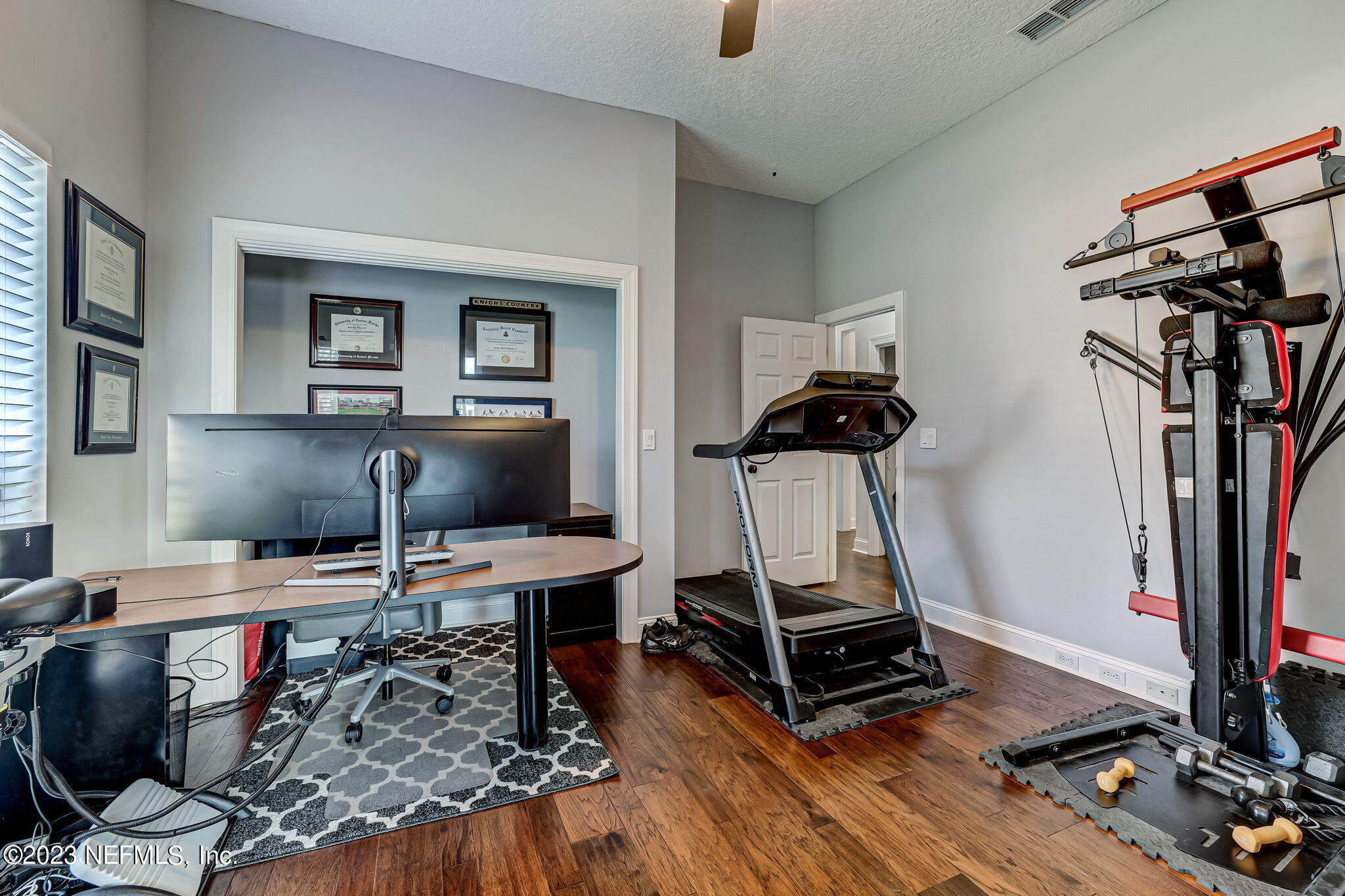 2011 Salt Myrtle Lane Fleming Island, FL 32003 - Photo 43 of 124 a view of a workspace with furniture and gym equipment