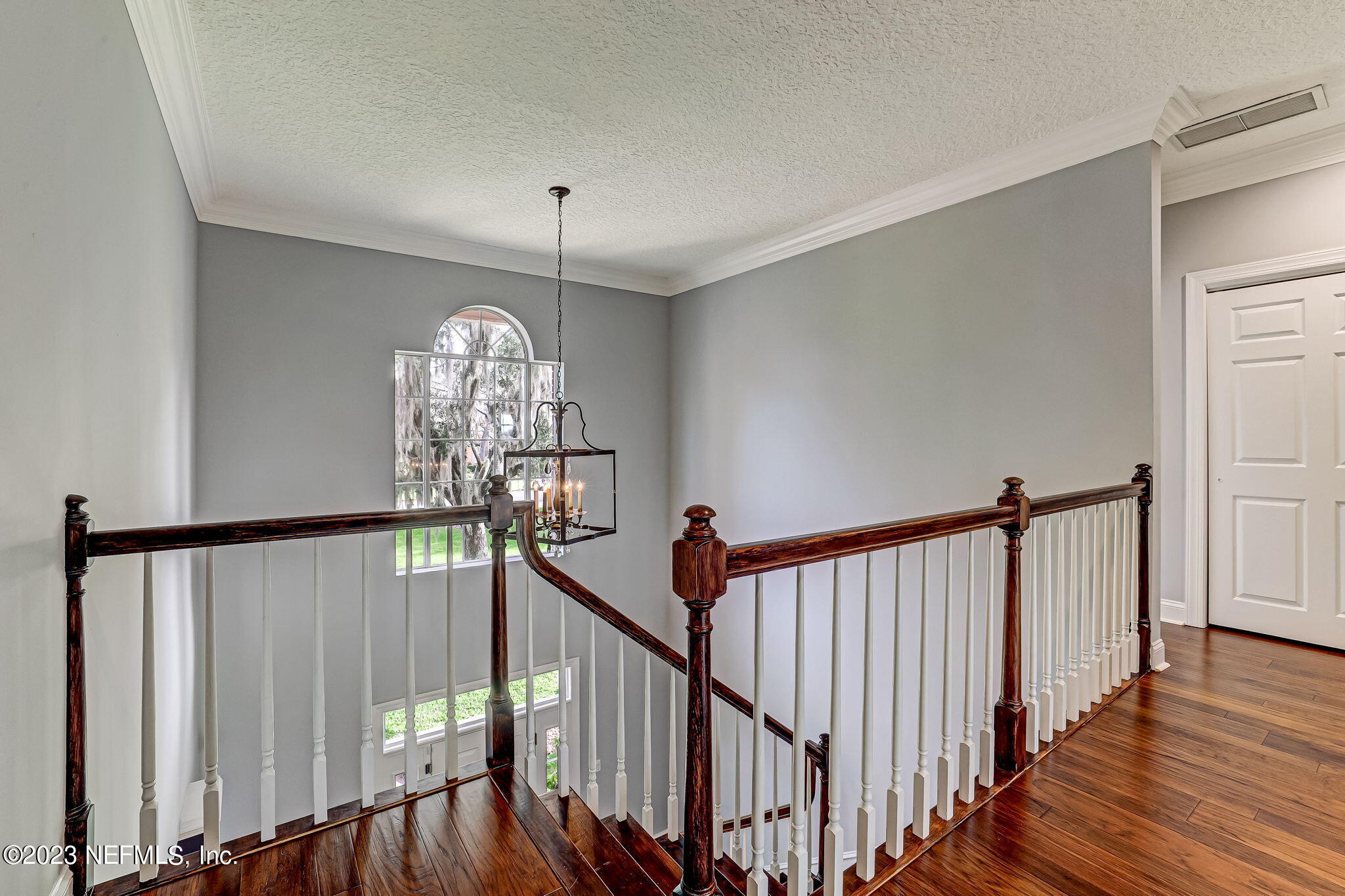 2011 Salt Myrtle Lane Fleming Island, FL 32003 - Photo 48 of 124 a view of a hallway with wooden floor and staircase