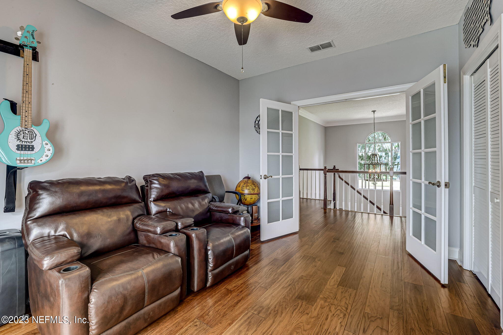 2011 Salt Myrtle Lane Fleming Island, FL 32003 - Photo 52 of 124 a living room with furniture and a chandelier