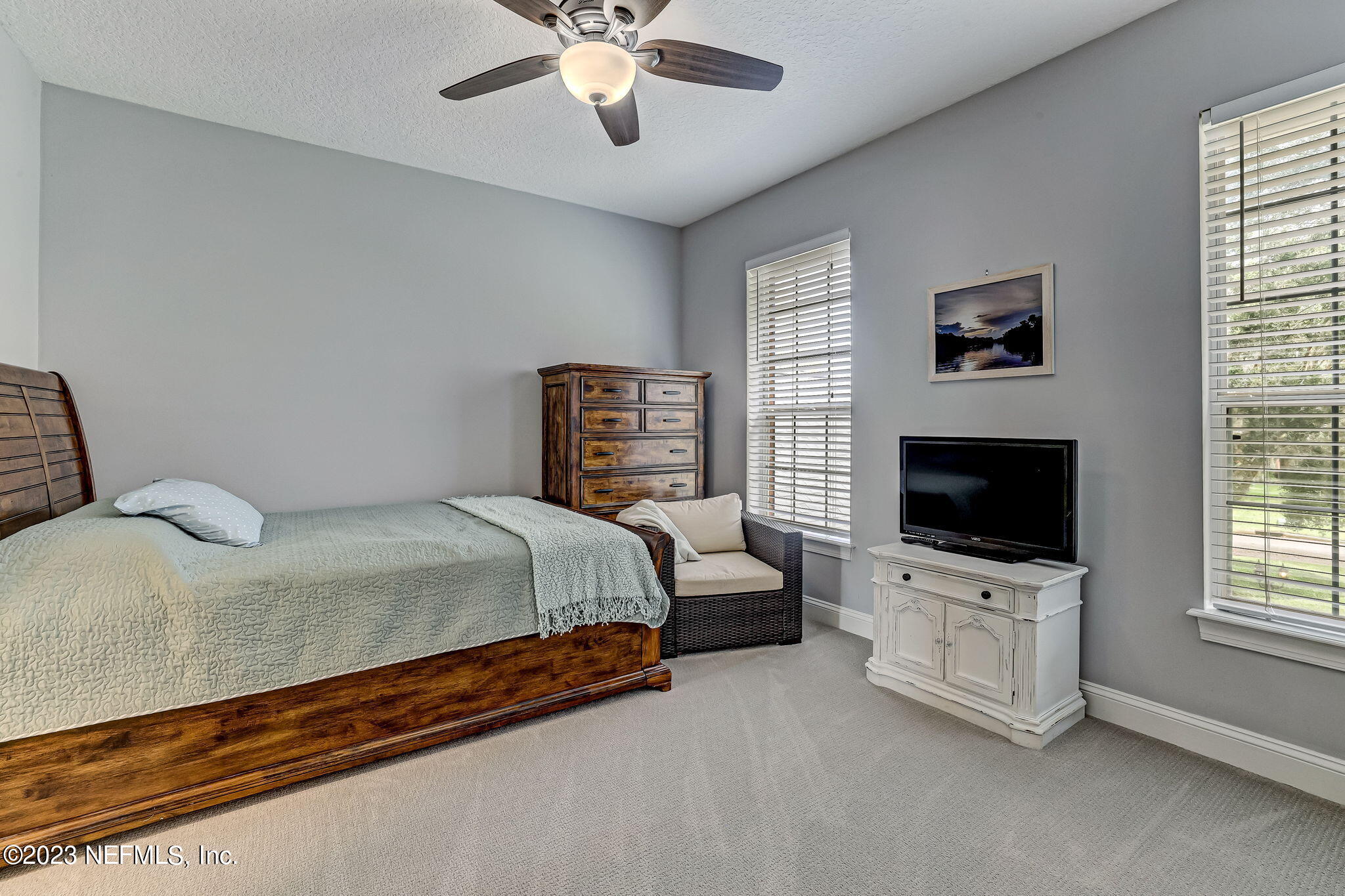 2011 Salt Myrtle Lane Fleming Island, FL 32003 - Photo 56 of 124 a bedroom with a bed and a flat screen tv