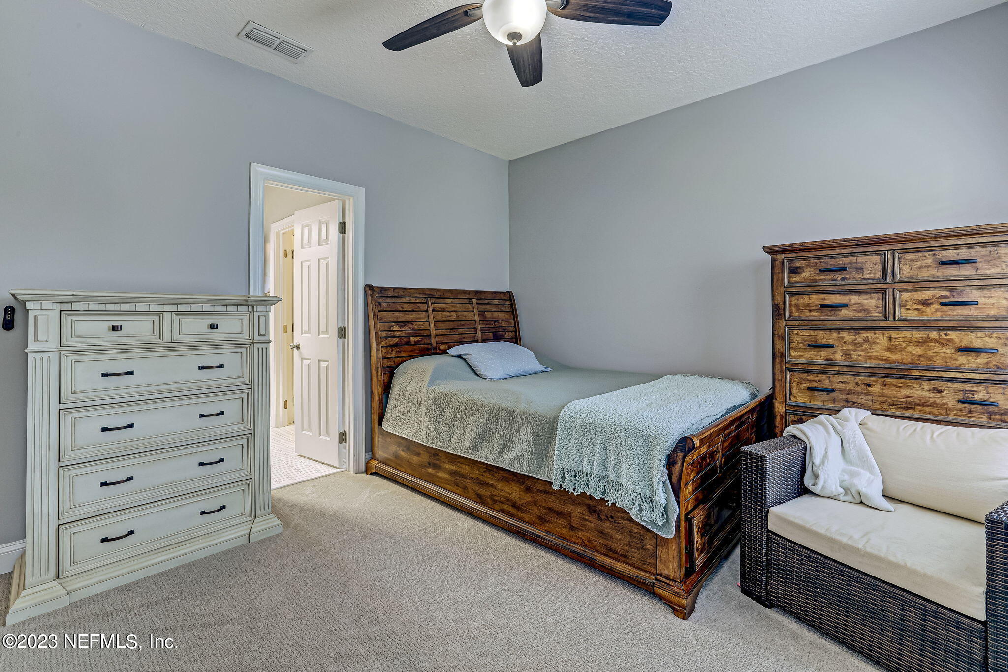 2011 Salt Myrtle Lane Fleming Island, FL 32003 - Photo 57 of 124 a bedroom with a bed and a chandelier