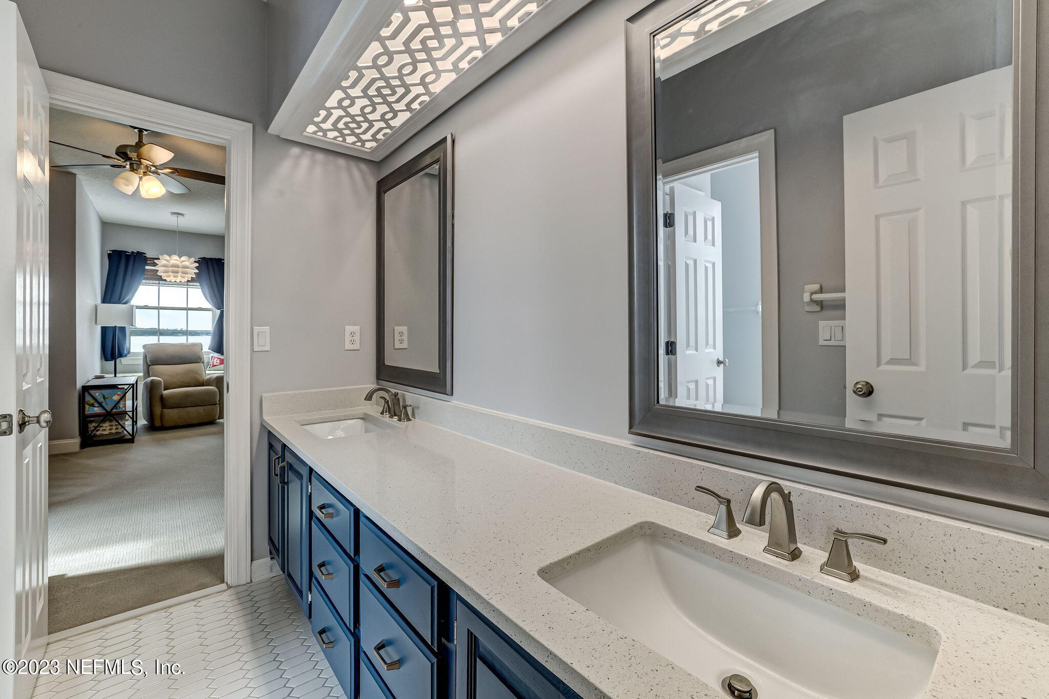 2011 Salt Myrtle Lane Fleming Island, FL 32003 - Photo 65 of 124 a en suite bathroom with a double vanity sink and a mirror
