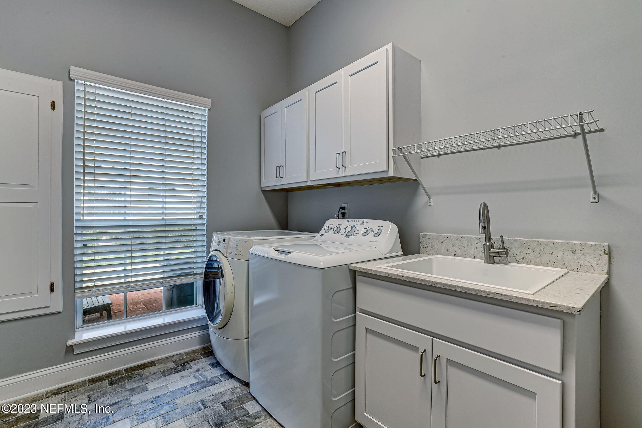 2011 Salt Myrtle Lane Fleming Island, FL 32003 - Photo 68 of 124 a utility room with dryer and washer