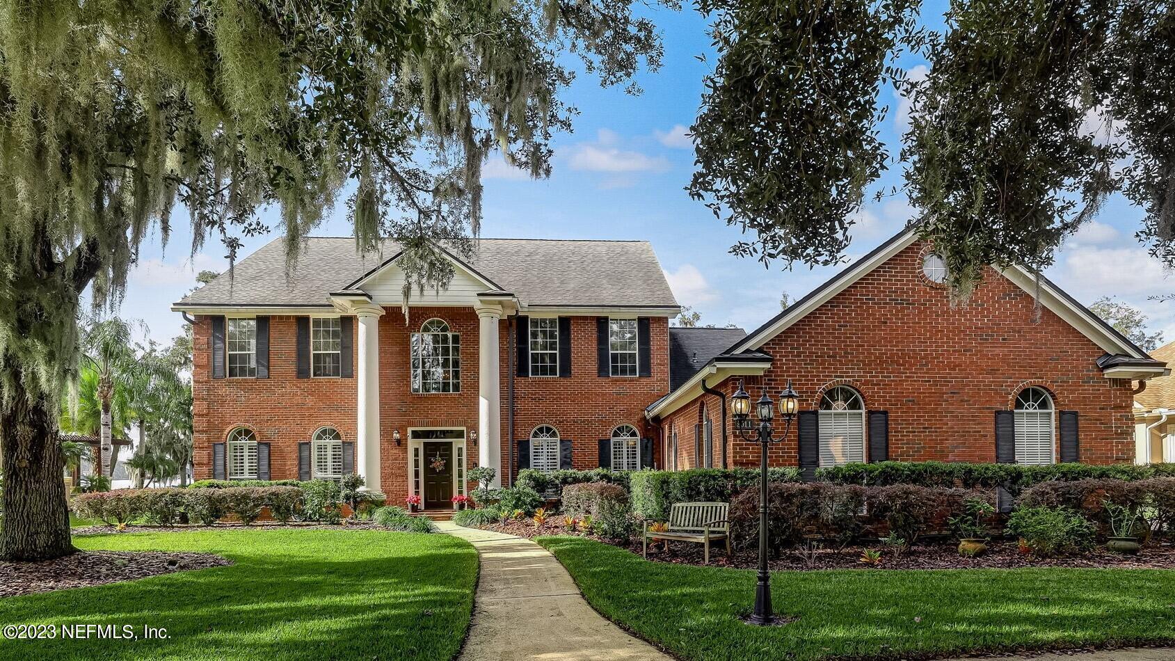 2011 Salt Myrtle Lane Fleming Island, FL 32003 - Photo 7 of 124 a front view of a house with a yard