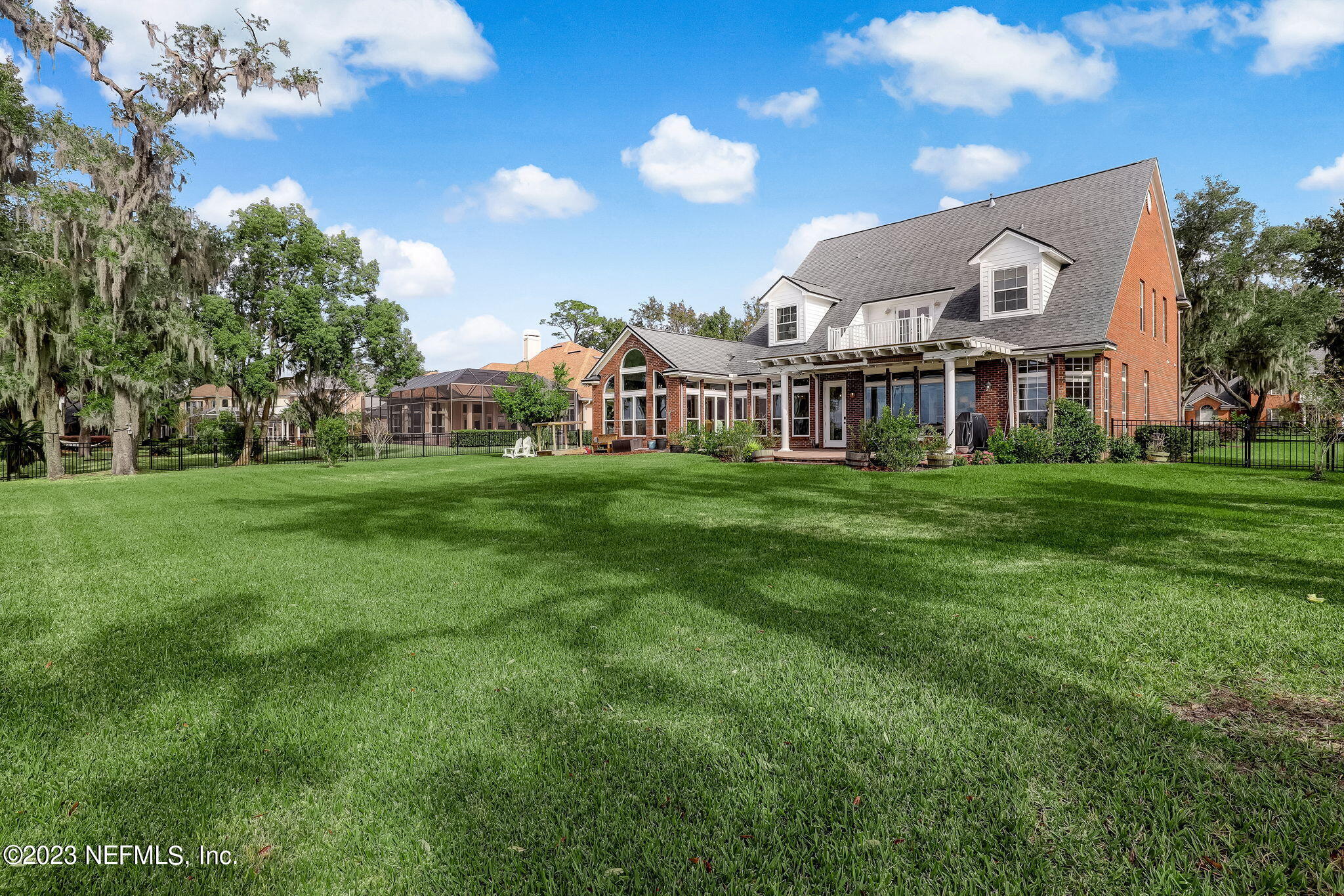 2011 Salt Myrtle Lane Fleming Island, FL 32003 - Photo 75 of 124 a view of a house with a big yard and large trees
