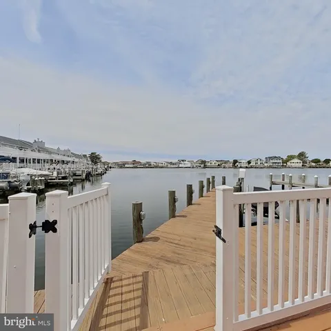 a view of a balcony with wooden floor and fence
