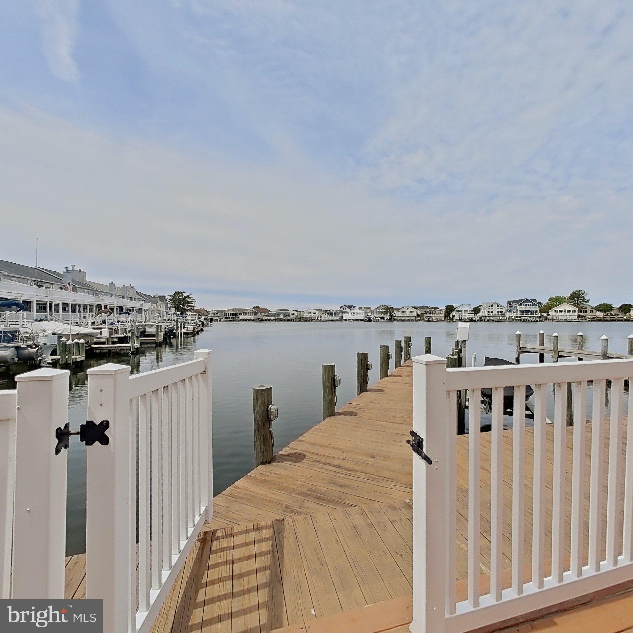 505 South Surf Road Ocean City, MD 21842 - Photo 1 of 49 a view of a balcony with wooden floor and fence