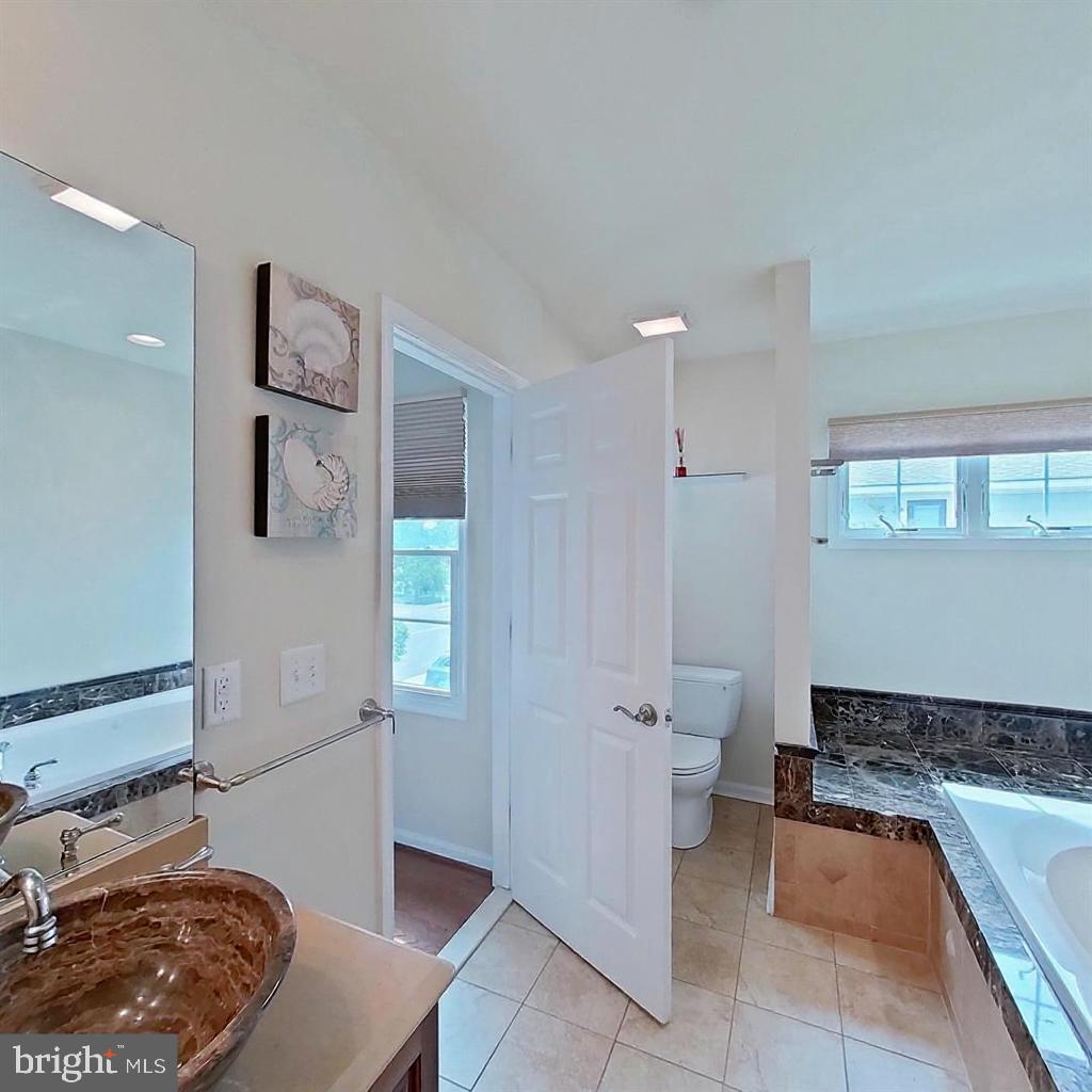 505 South Surf Road Ocean City, MD 21842 - Photo 11 of 49 a bedroom with a bed and a view of bathroom