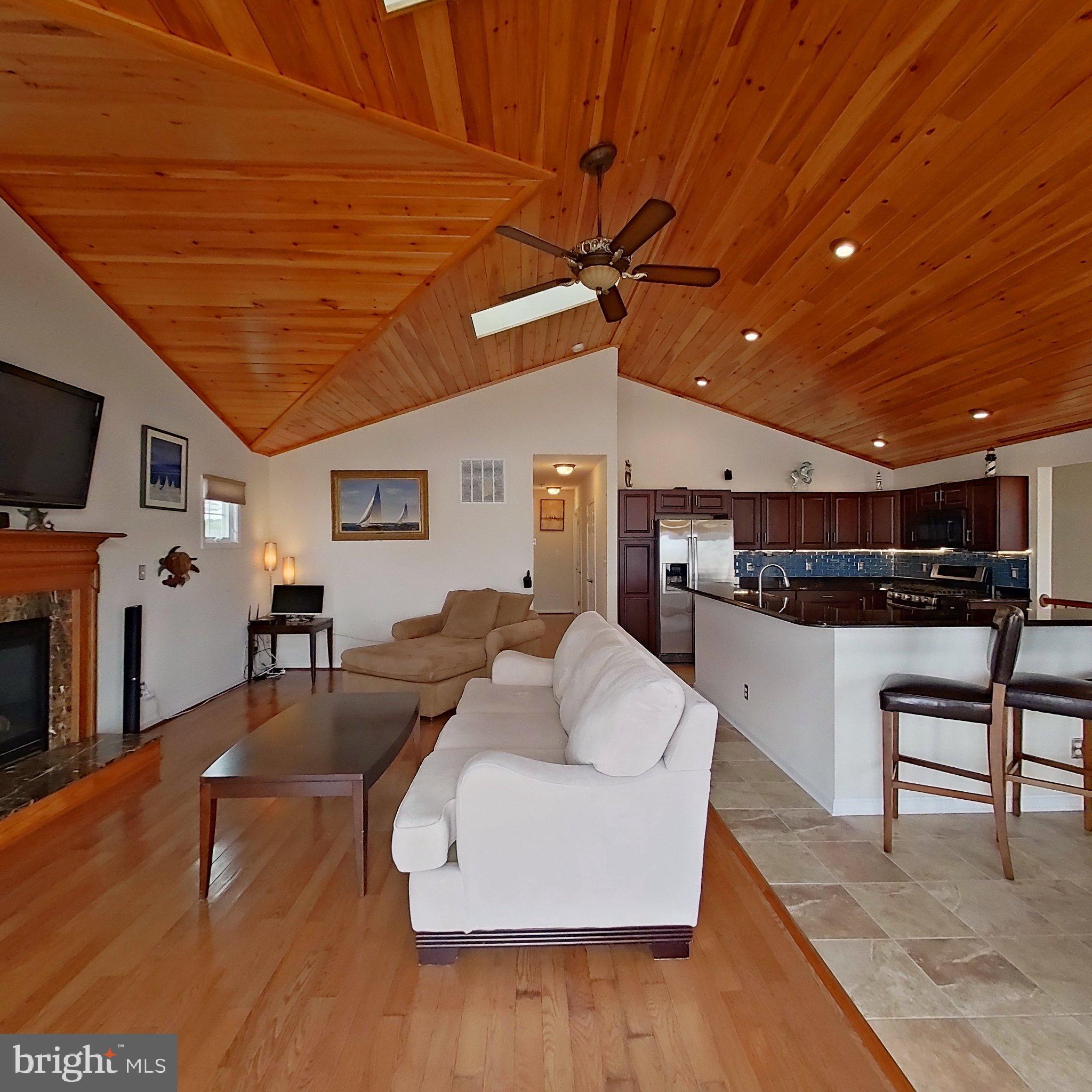 505 South Surf Road Ocean City, MD 21842 - Photo 27 of 49 a living room with furniture and a flat screen tv