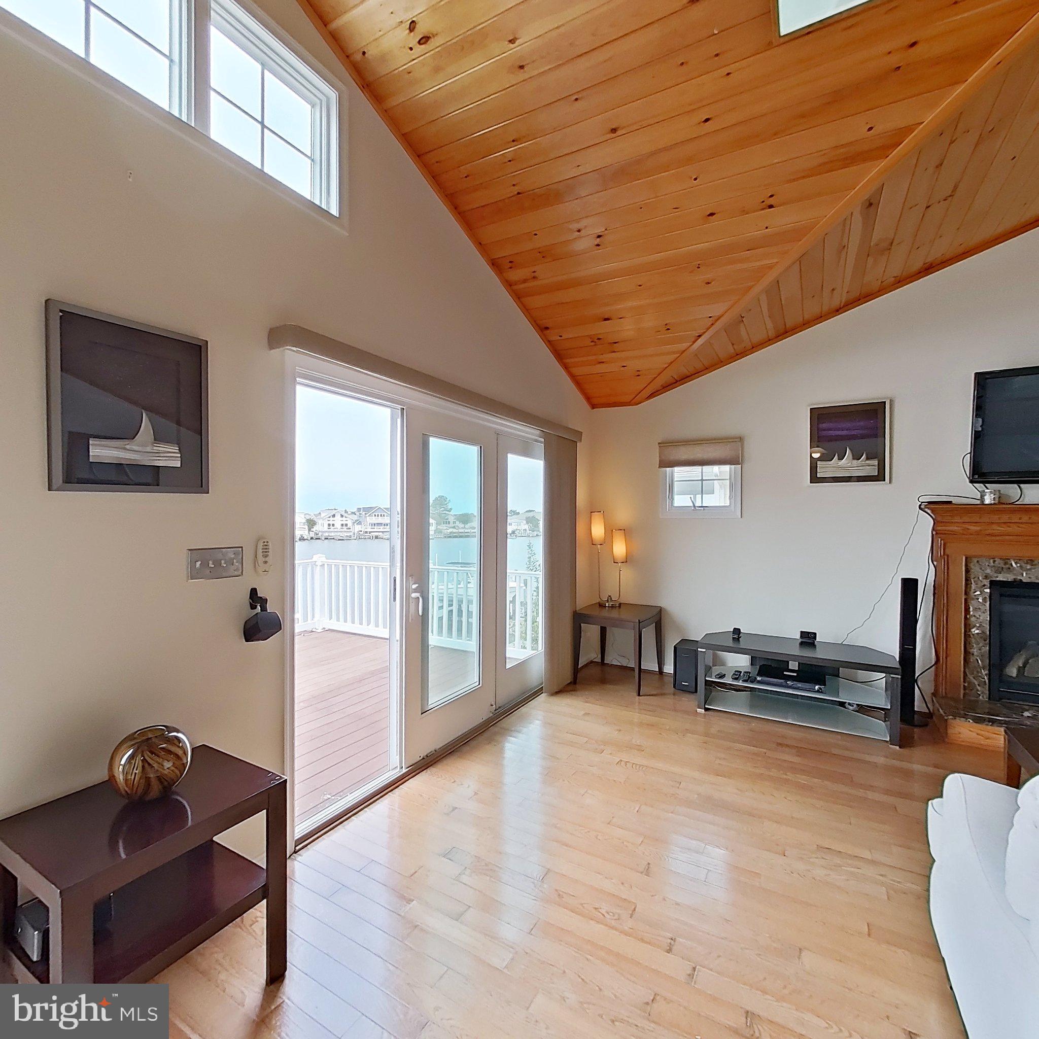 505 South Surf Road Ocean City, MD 21842 - Photo 31 of 49 a living room with furniture and a flat screen tv