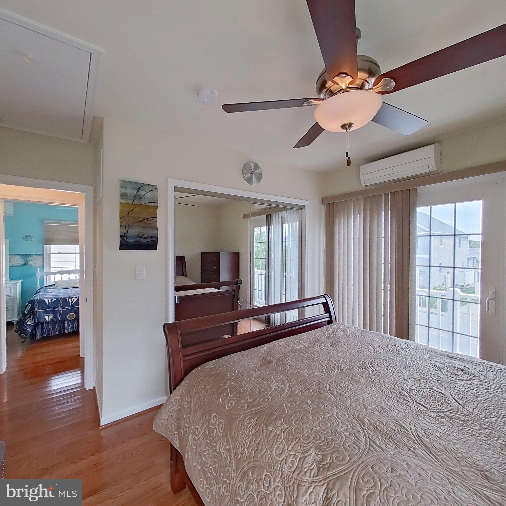 505 South Surf Road Ocean City, MD 21842 - Photo 34 of 49 a bedroom with a large bed and a chandelier