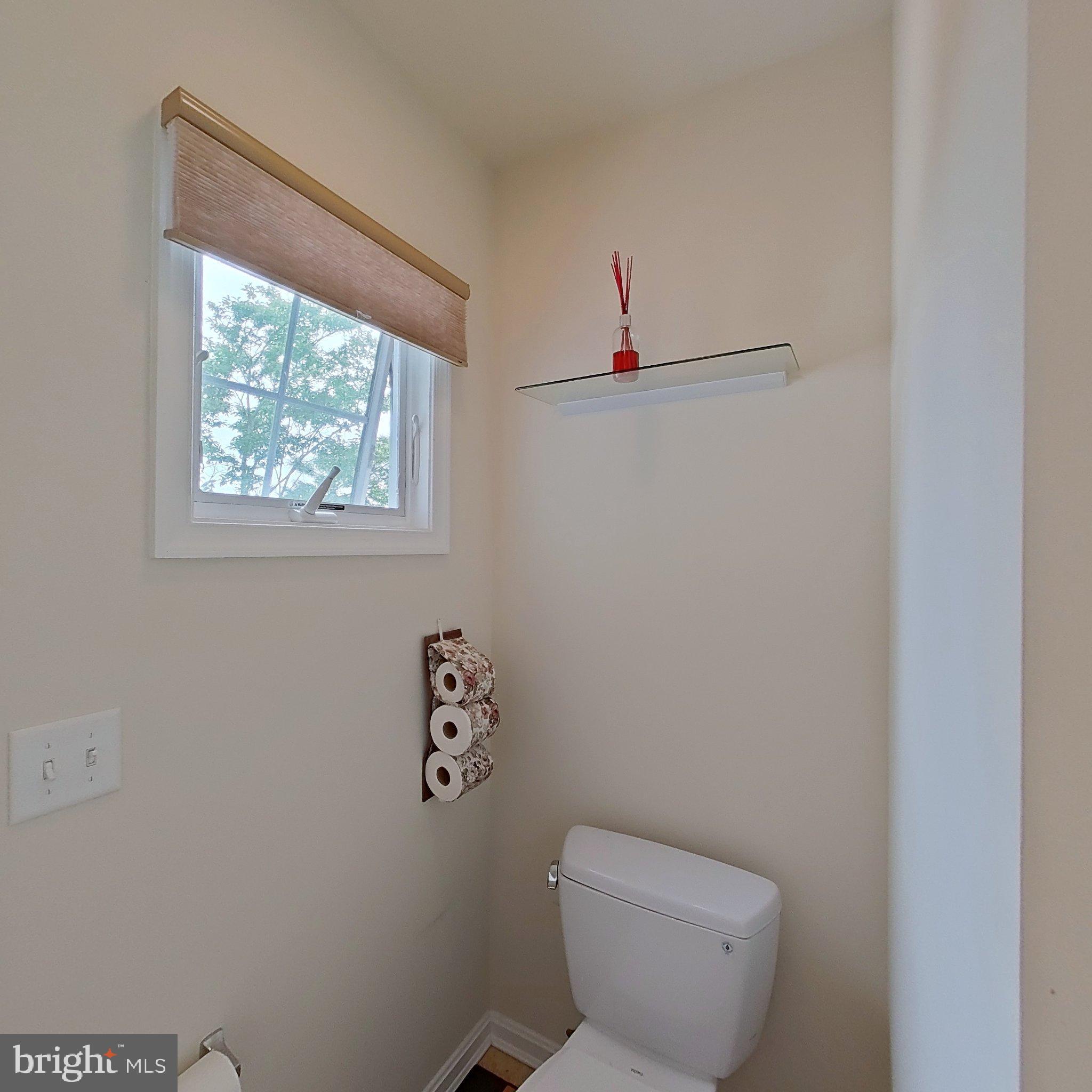 505 South Surf Road Ocean City, MD 21842 - Photo 38 of 49 a bathroom with a toilet and a window