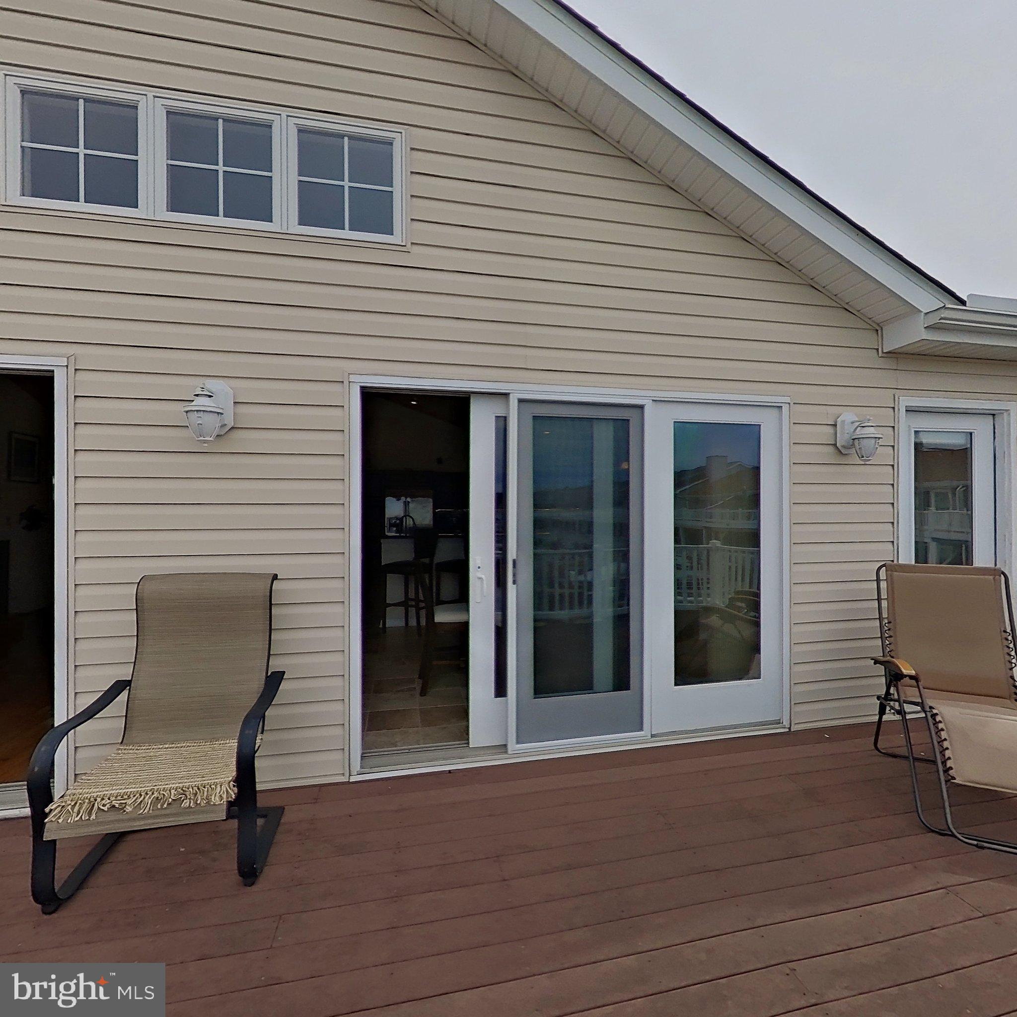 505 South Surf Road Ocean City, MD 21842 - Photo 43 of 49 a view of a house with a chairs and table in a patio