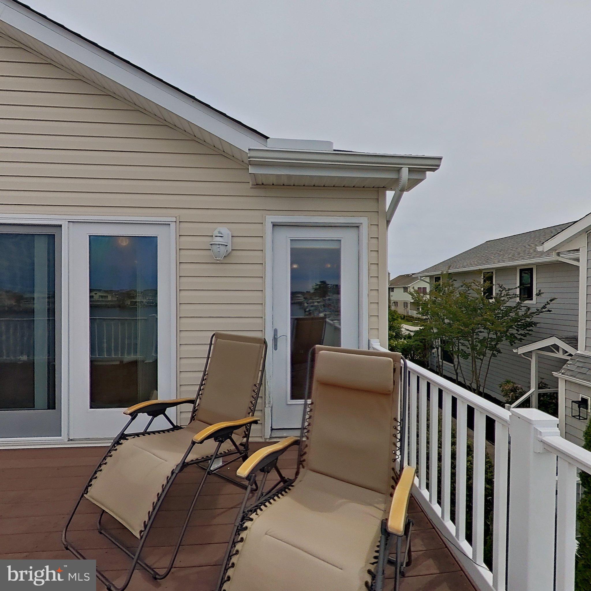 505 South Surf Road Ocean City, MD 21842 - Photo 46 of 49 a balcony with furniture and a window