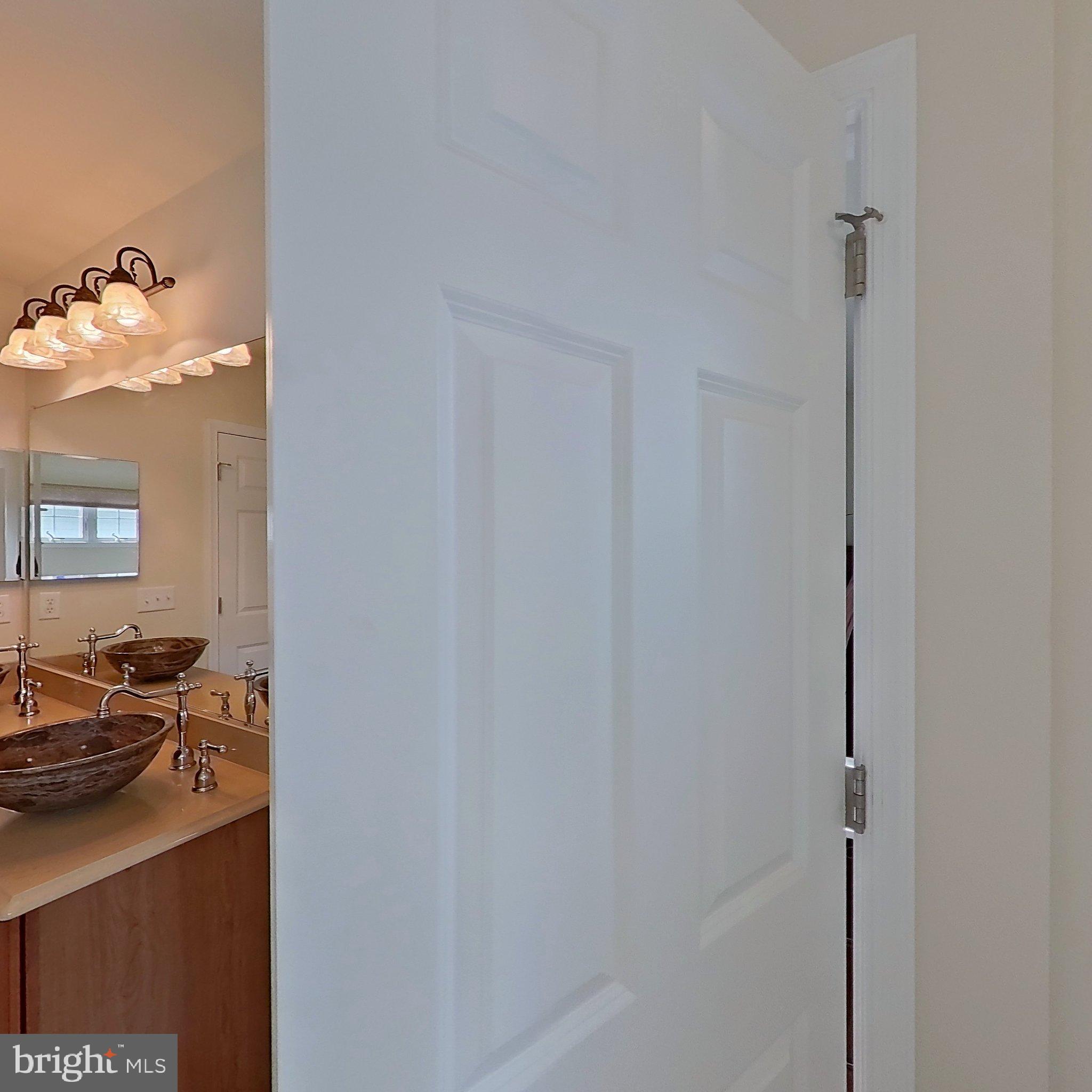 505 South Surf Road Ocean City, MD 21842 - Photo 49 of 49 a en suite bathroom with a sink and a mirror