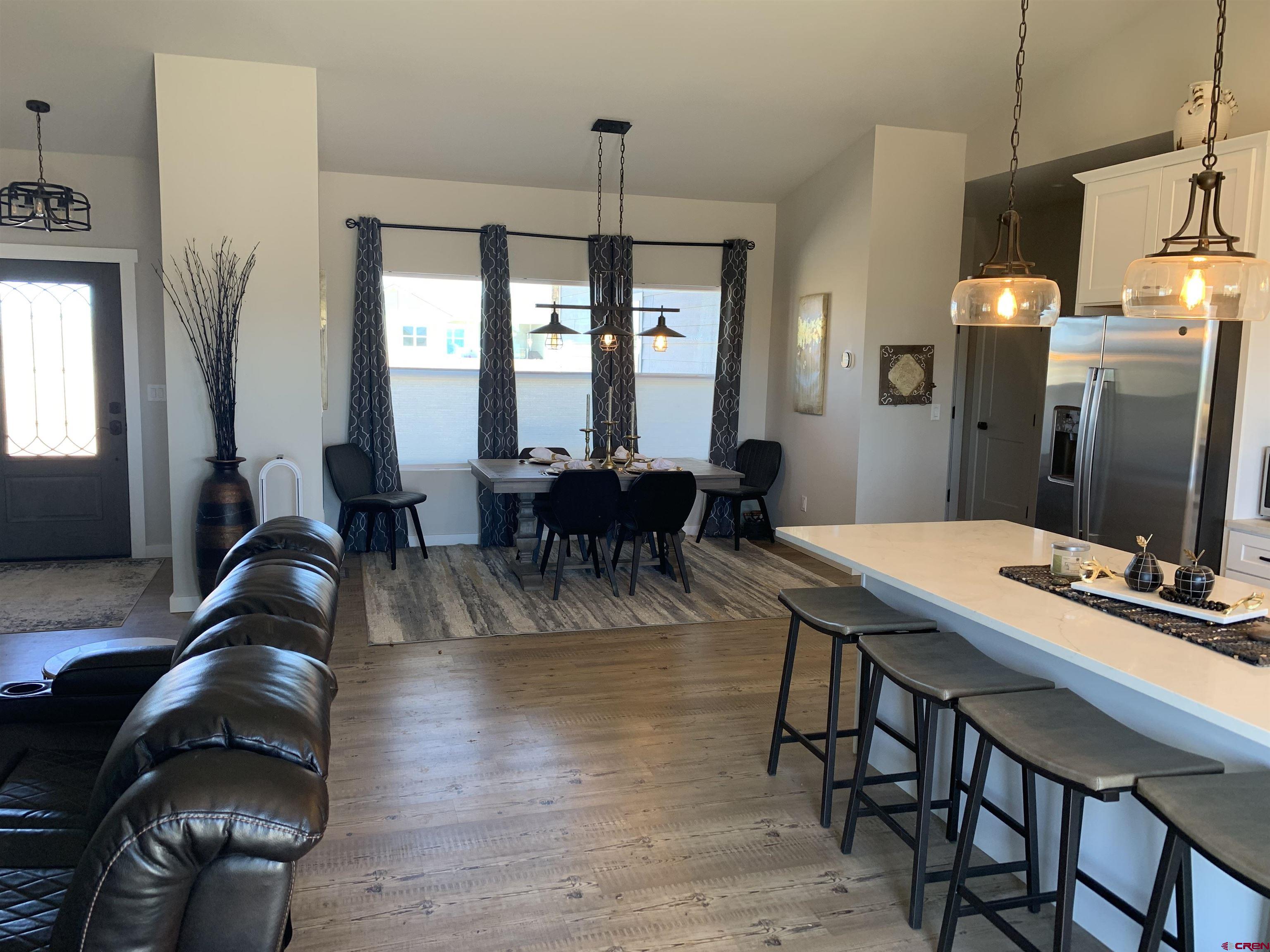 10400 Road 23.5 Cortez, CO 81321 - Photo 11 of 34 a view of a dining room with furniture window and wooden floor