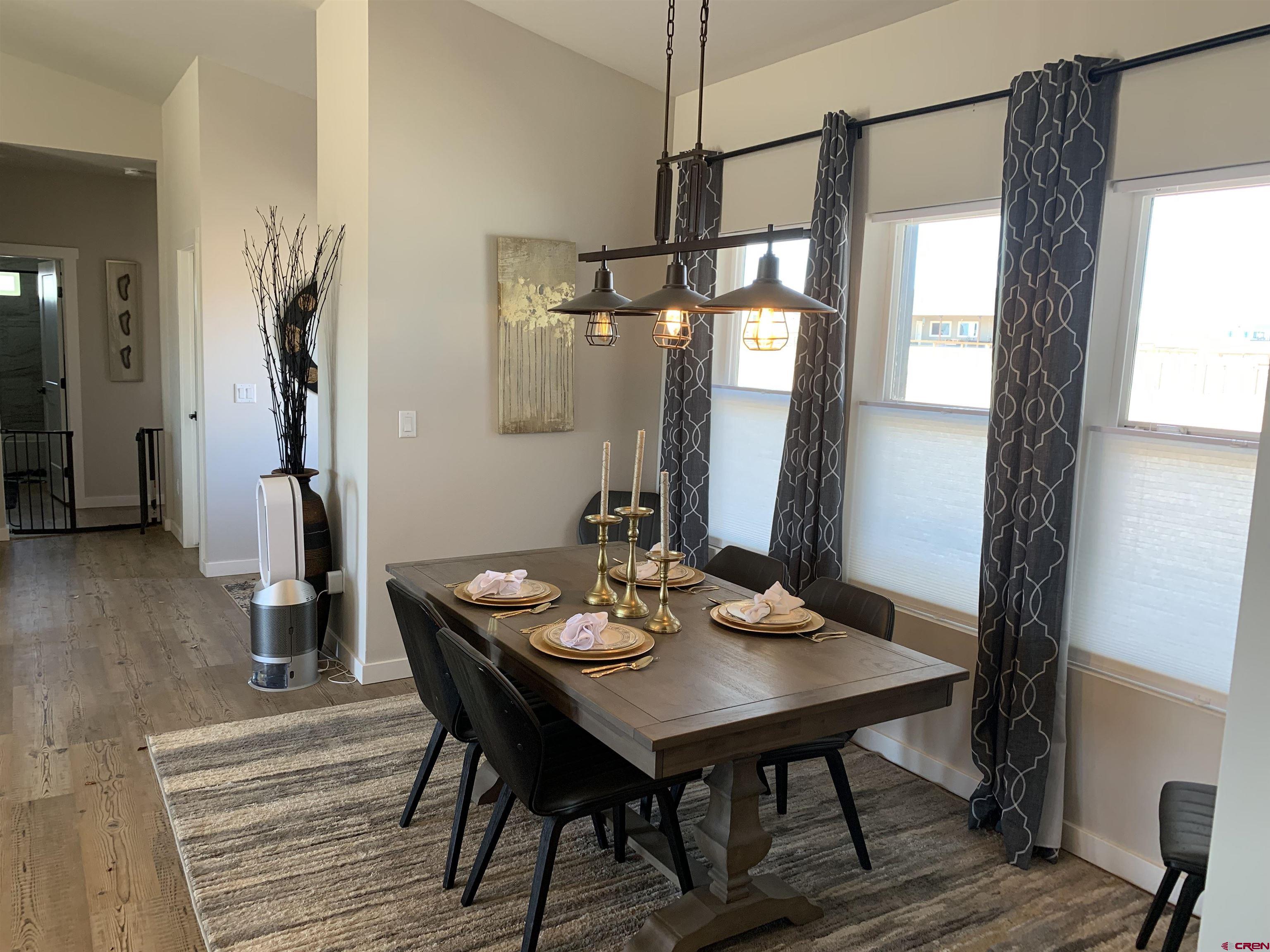 10400 Road 23.5 Cortez, CO 81321 - Photo 12 of 34 a view of a dining room with furniture and wooden floor