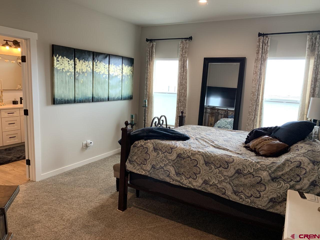 10400 Road 23.5 Cortez, CO 81321 - Photo 13 of 34 a bedroom with a bed and a mirror