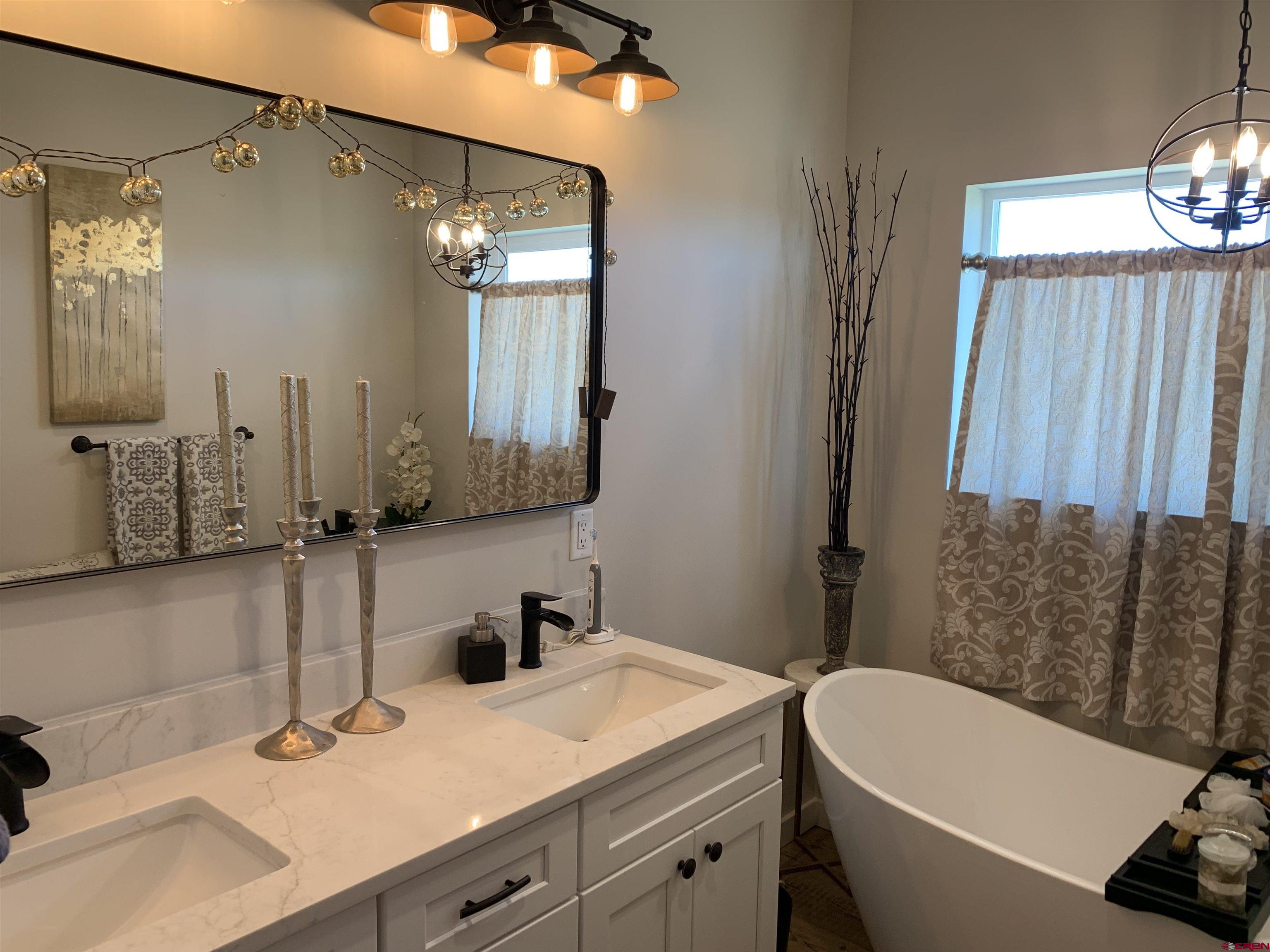 10400 Road 23.5 Cortez, CO 81321 - Photo 14 of 34 a bathroom with a sink and a mirror
