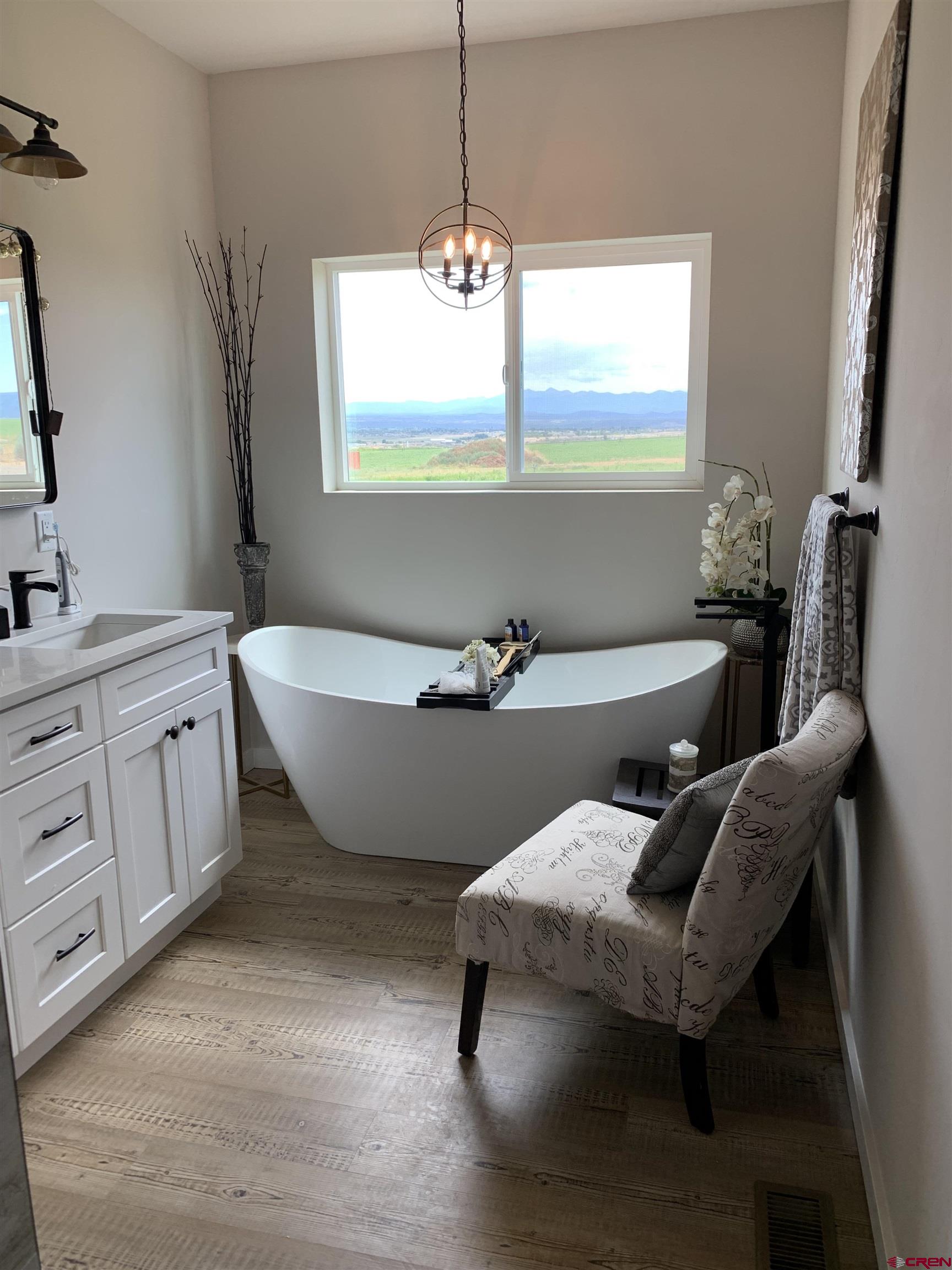 10400 Road 23.5 Cortez, CO 81321 - Photo 15 of 34 a living room with furniture a window and a chandelier