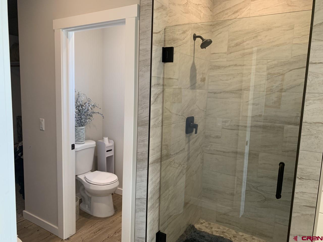 10400 Road 23.5 Cortez, CO 81321 - Photo 17 of 34 a bathroom with a toilet and a shower