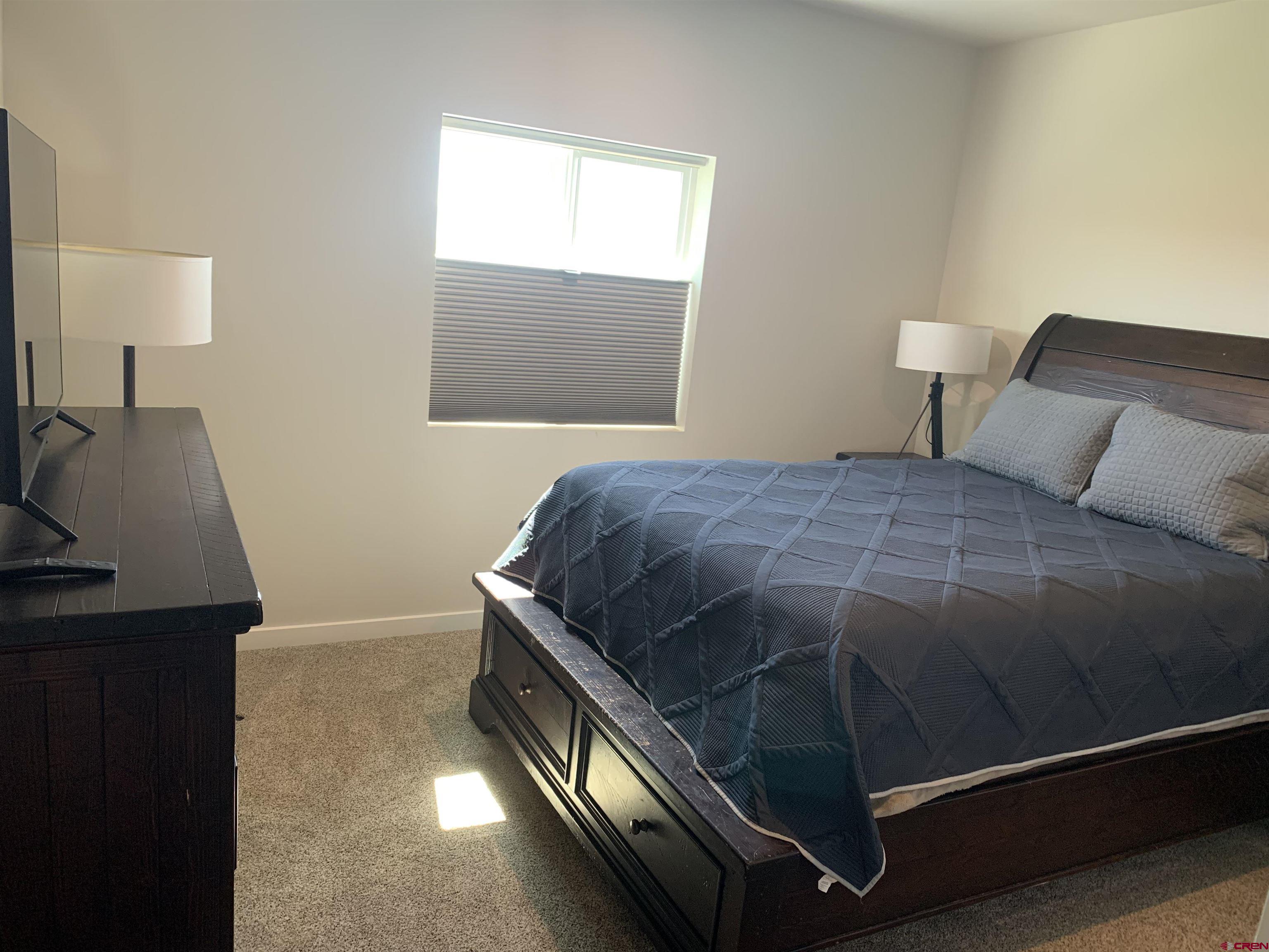 10400 Road 23.5 Cortez, CO 81321 - Photo 20 of 34 a bedroom with a bed and lamp