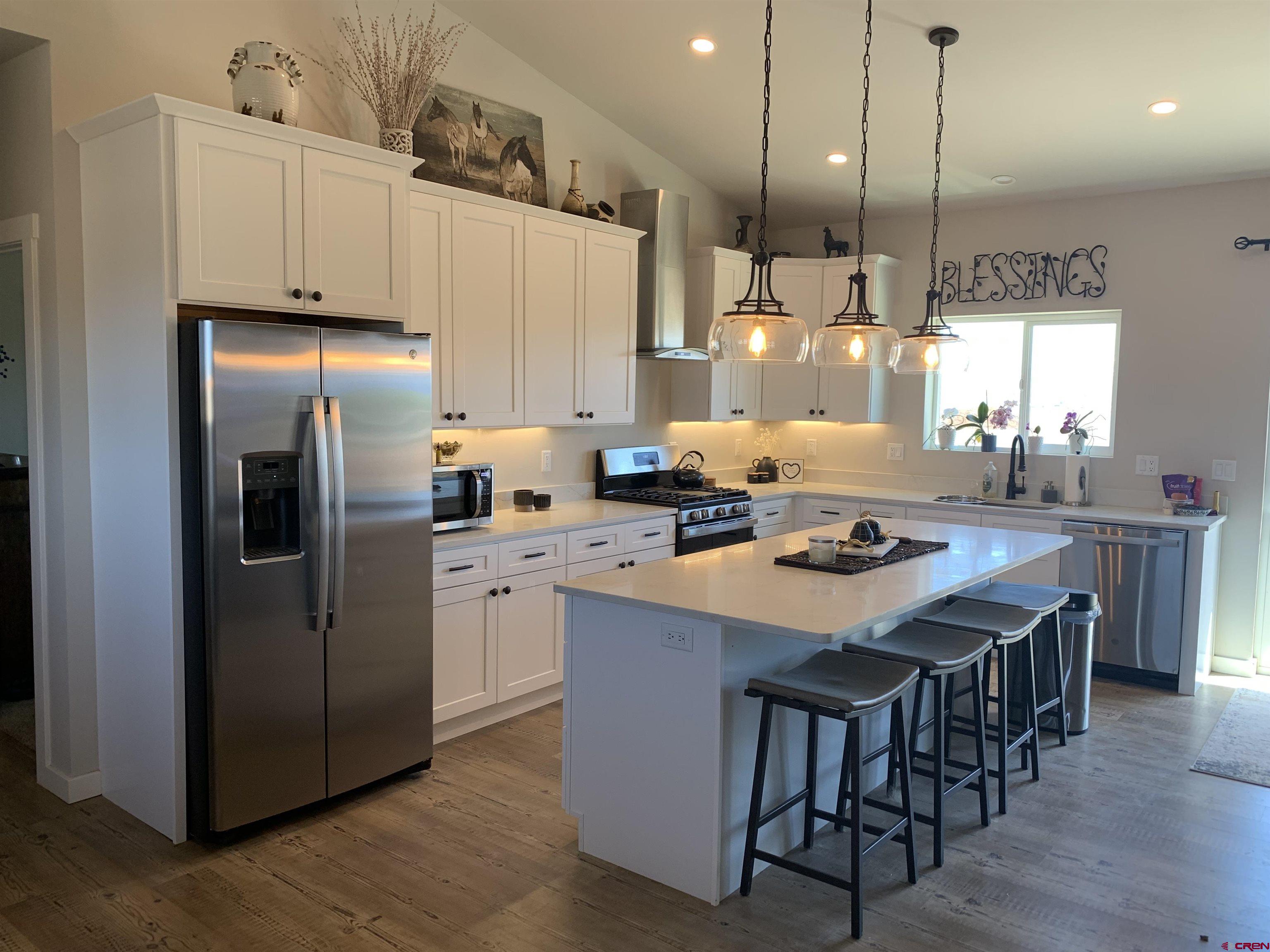 10400 Road 23.5 Cortez, CO 81321 - Photo 6 of 34 a kitchen with refrigerator and chairs