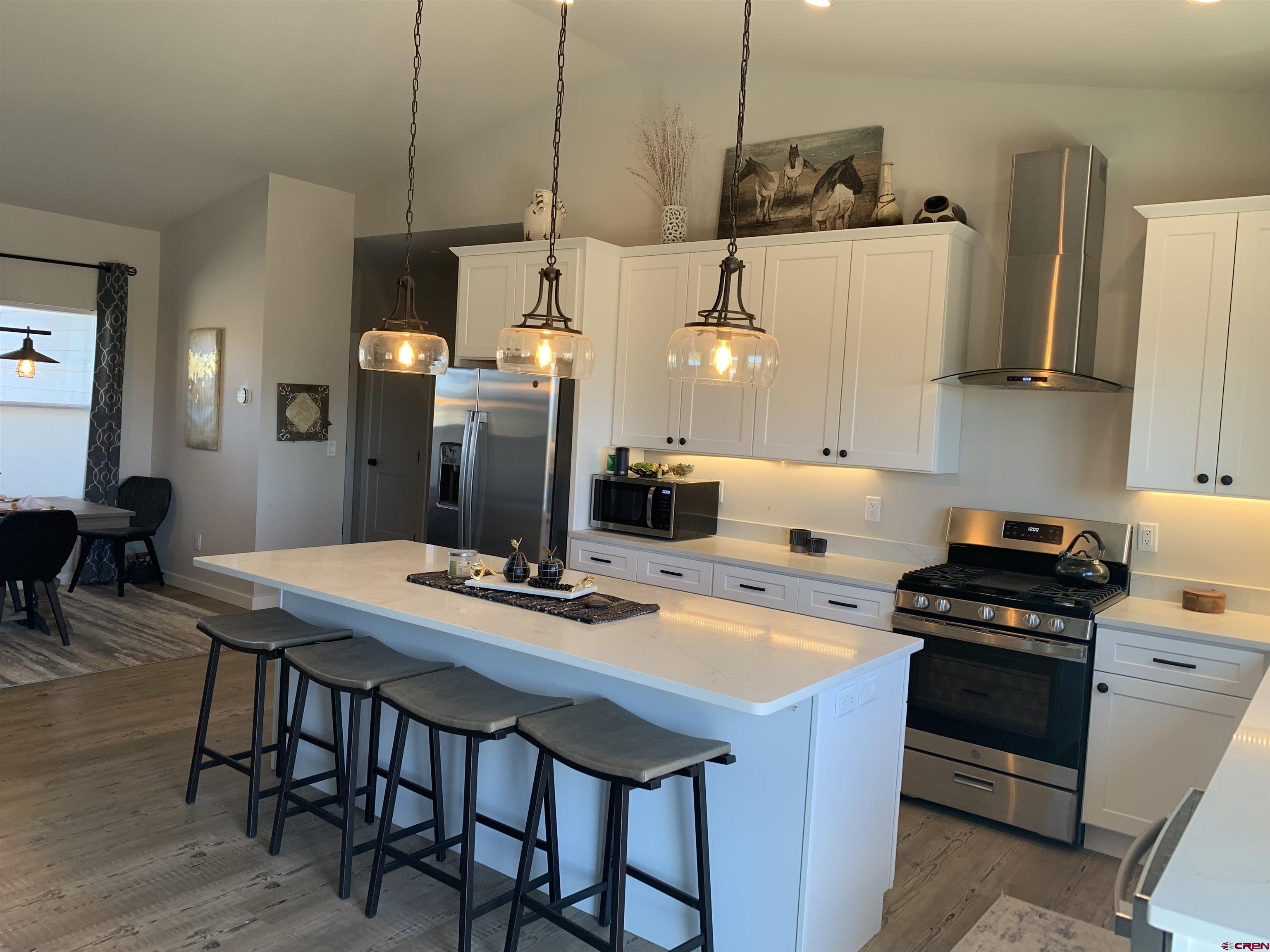 10400 Road 23.5 Cortez, CO 81321 - Photo 8 of 34 a kitchen with a dining table and chairs